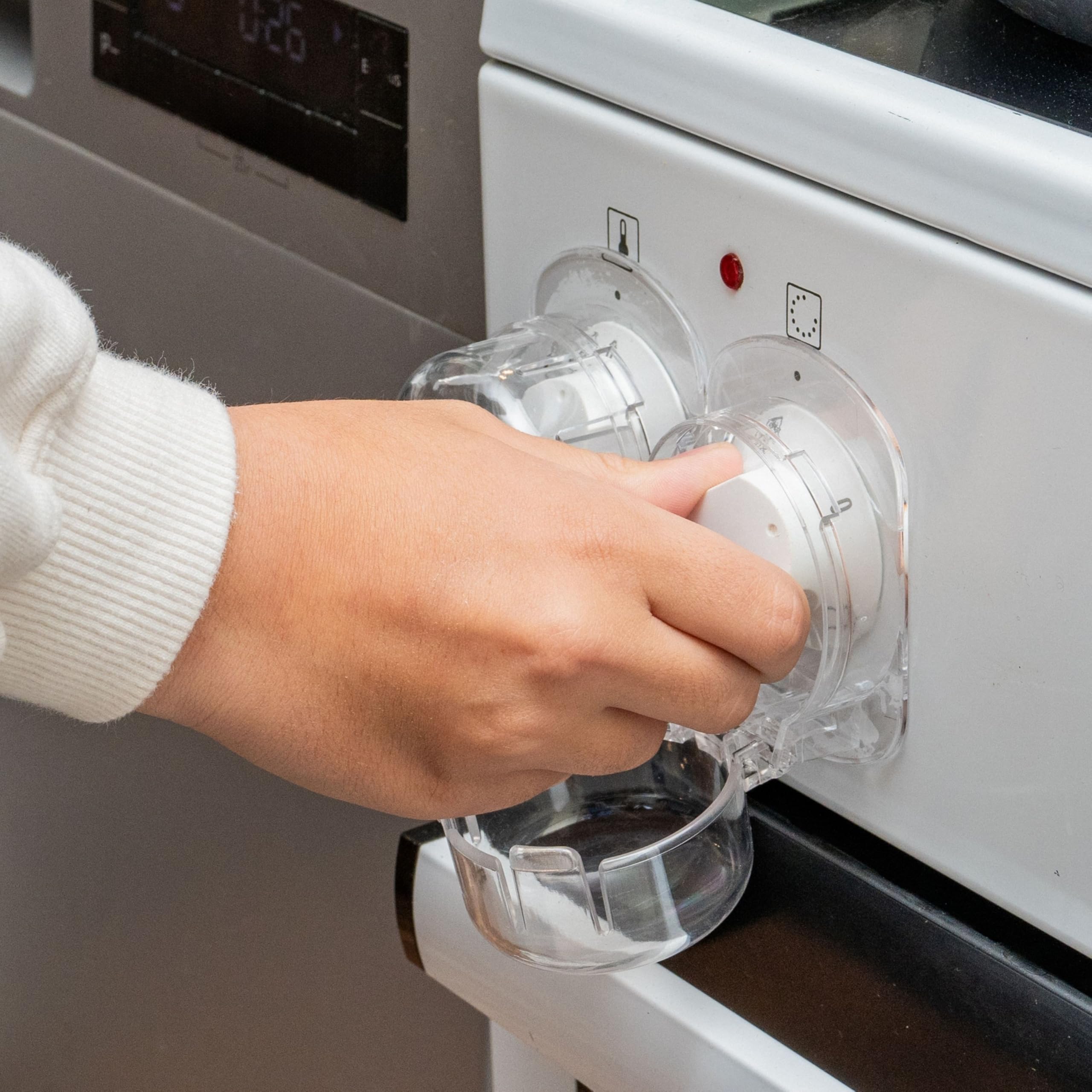 Blokada przed dziećmi do pokręteł kuchenek, 3 szt, przezroczyste, do dużych pokręteł o maks. Ø 52 x 45 mm, rozstaw pokręteł min. 63 mm, blokada panelu sterowania, przycisk blokady przed dziećmi