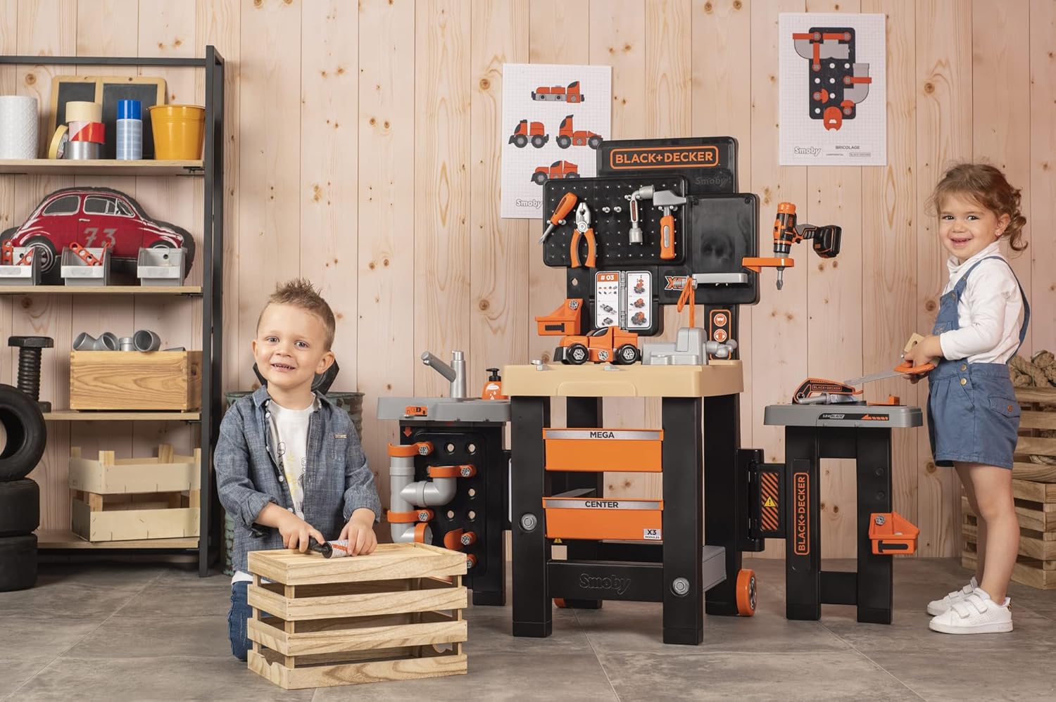 Child playing with the mechanical section of the Smoby Black+Decker Mega Center, using a hammer