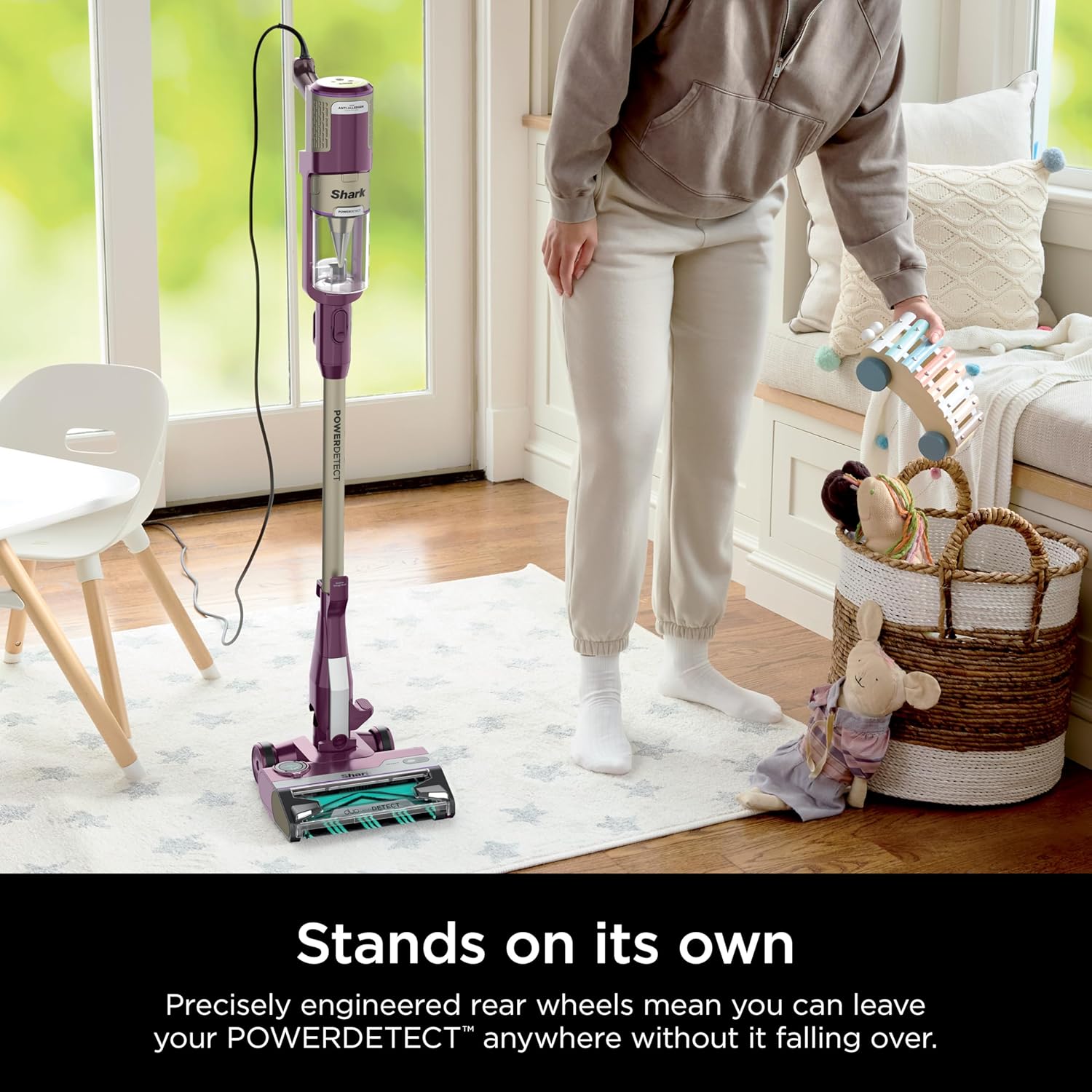 Shark POWERDETECT vacuum standing upright on its own in a room.