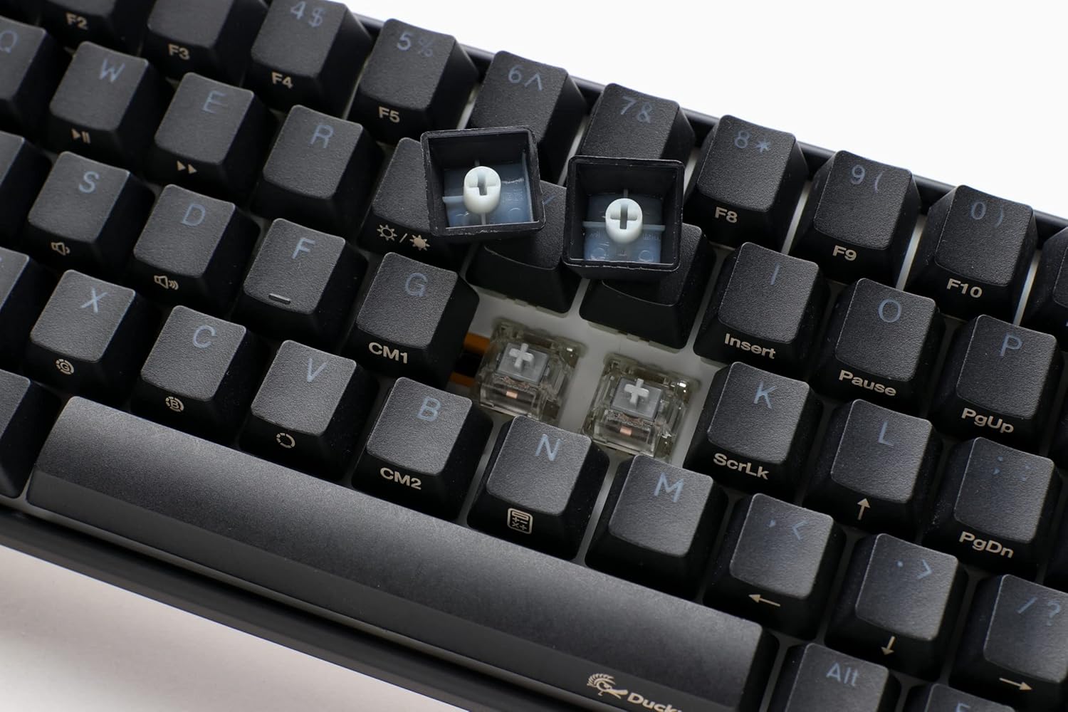 Close-up of Ducky One 3 keyboard with keycaps removed, showing hot-swappable switches