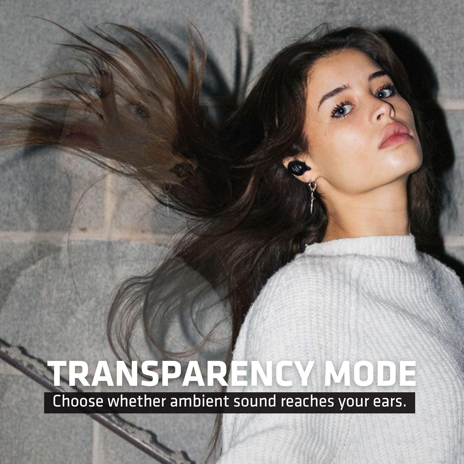 Woman listening with Wicked Audio Mojo 300 earbuds, illustrating Transparency Mode