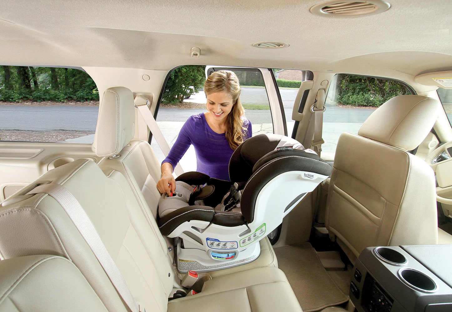 Woman closing the ClickTight panel on the Britax Boulevard car seat to secure installation.