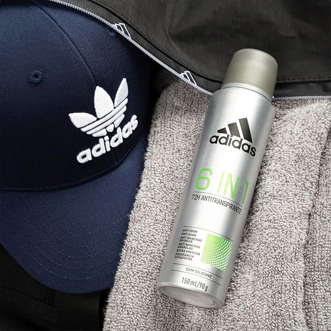 Desodorante Adidas 6 em 1 em um cenario de academia com bone e toalha