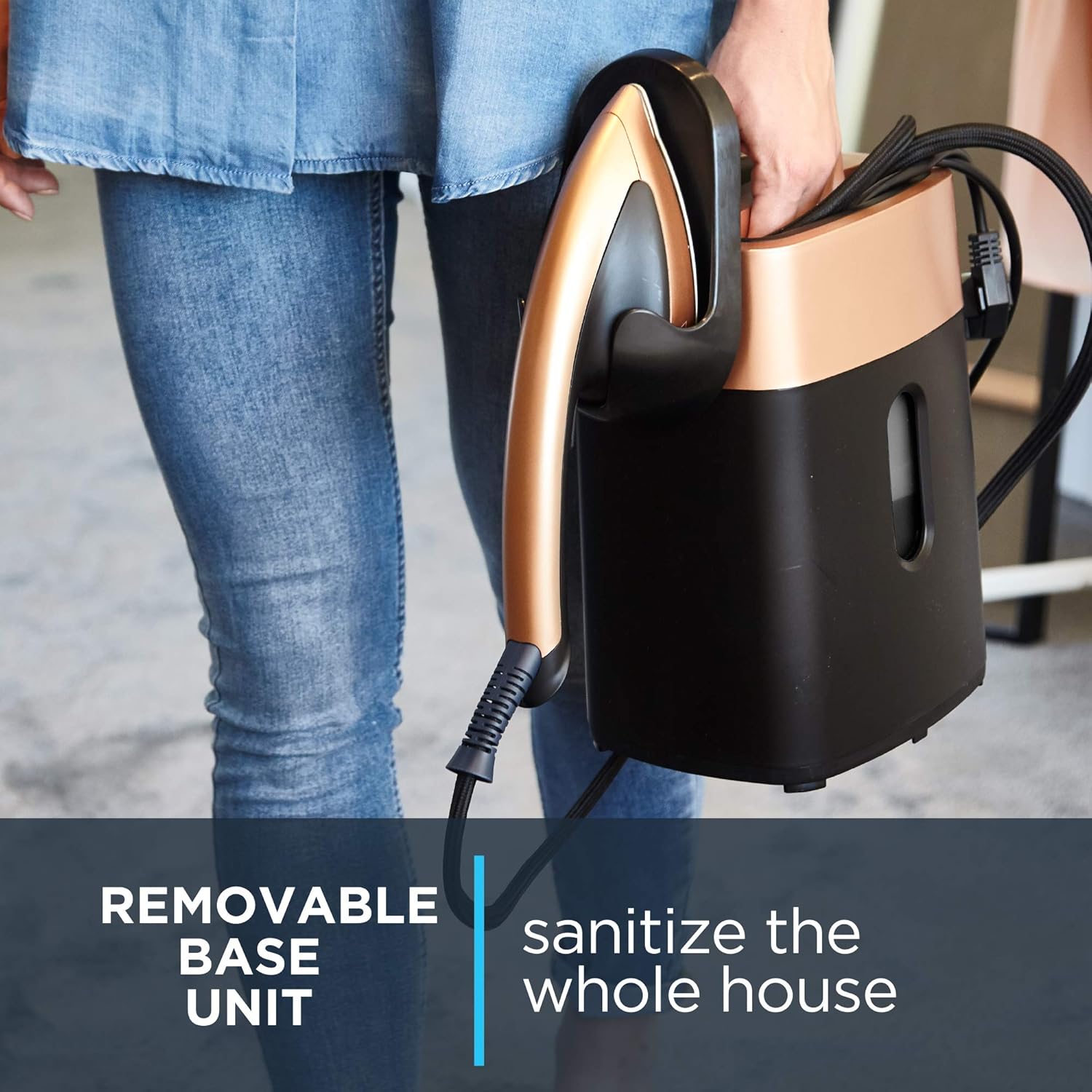 Removable base unit of the Rowenta IXEO QR1020 steamer, showing a hand carrying the portable steam unit.