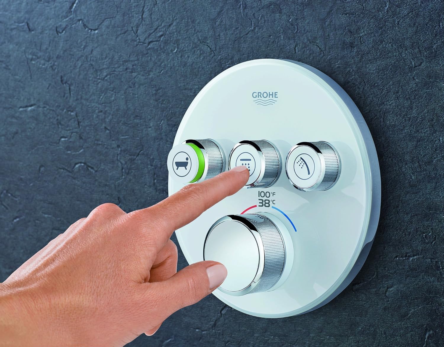 A hand pressing one of the SmartControl buttons to activate a shower function.
