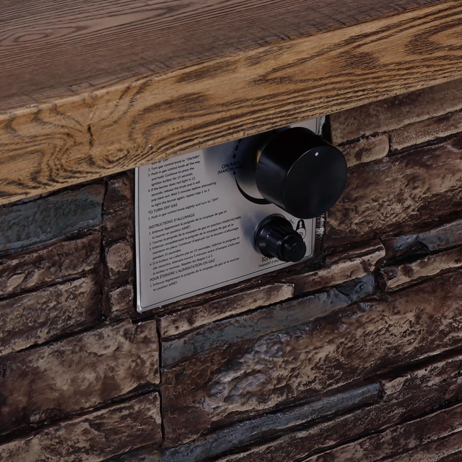 Close-up of the control panel on the Afterglow fire pit table, showing the control knob and pulse ignition button.