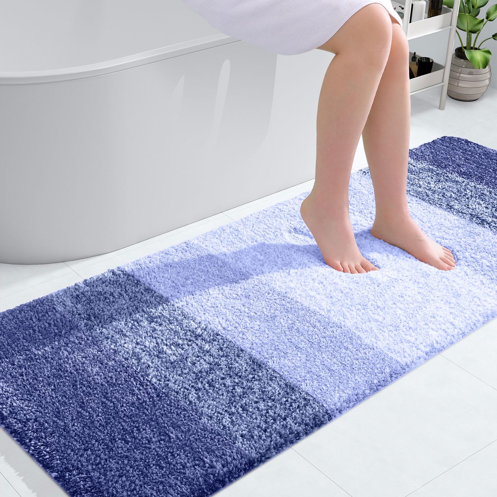OLANLY large bathroom rug in blue-violet, showing full 54x24 dimensions on tile floor. | Mubboo
