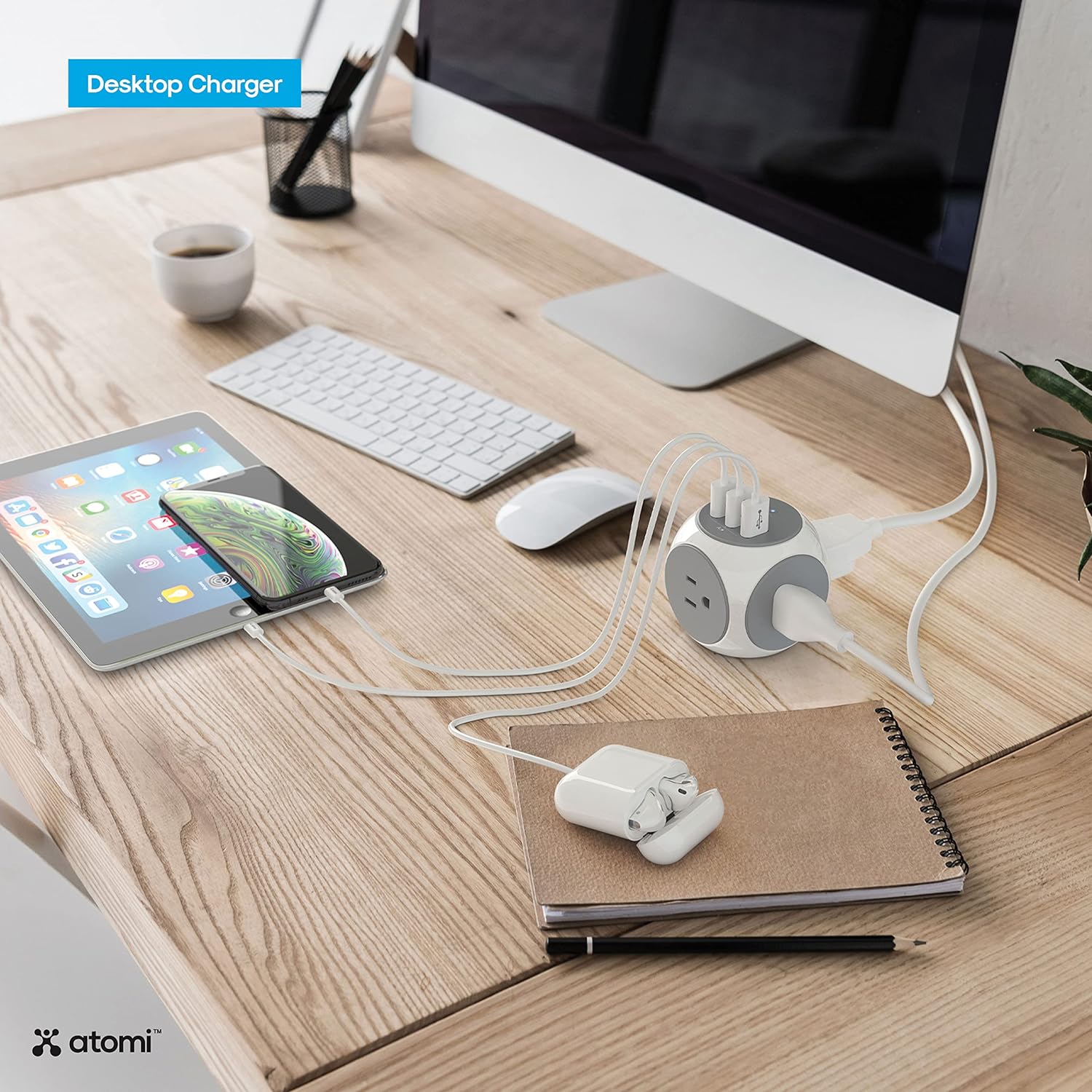 Atomi Power Cube used as a desktop charger on a desk with multiple devices