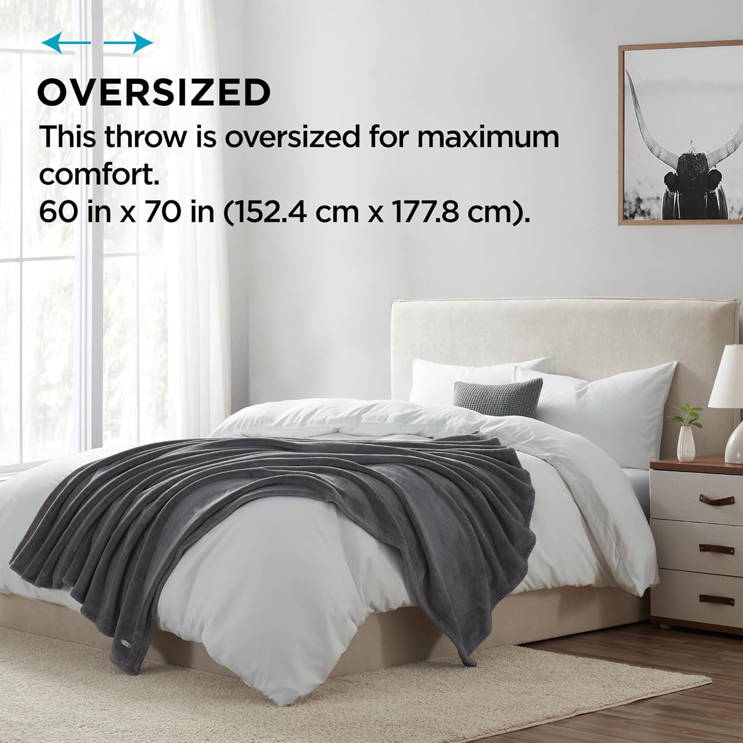 Oversized Brookstone Nap Plush Throw Blanket spread across a bed, showing its large dimensions.