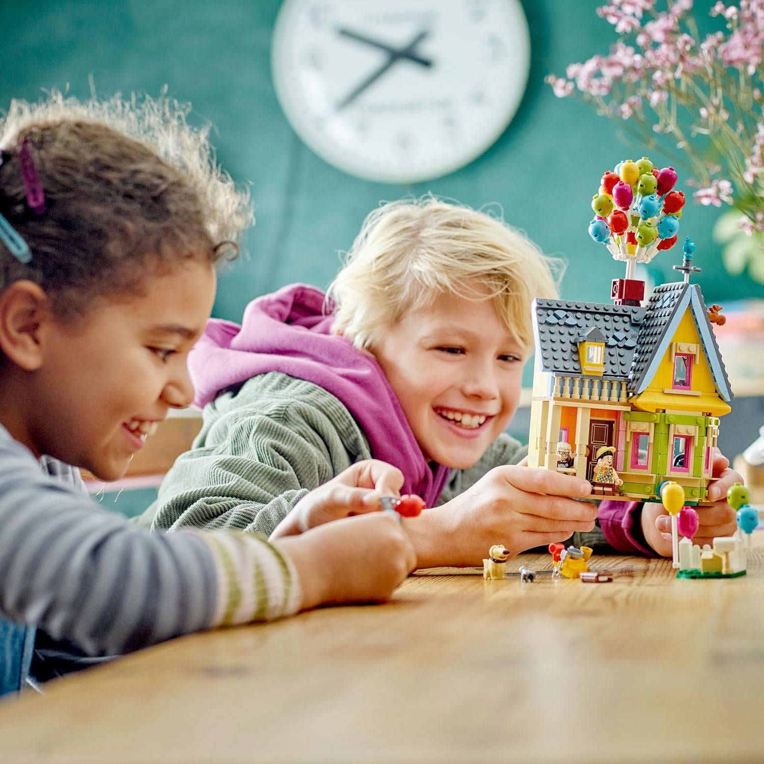 Two children playing with the assembled LEGO Up House set.
