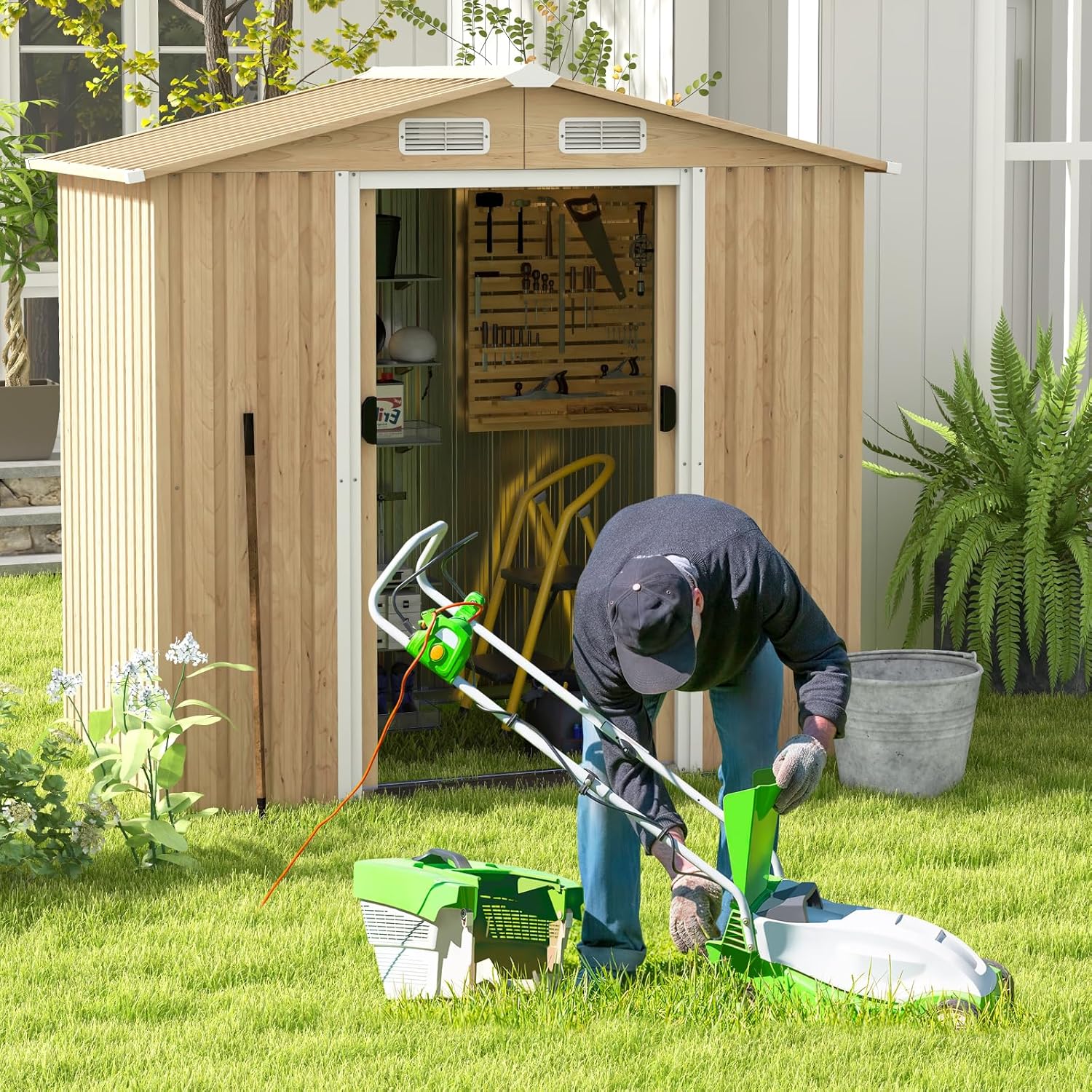 Person operating a lawnmower near the HOMASIS garden shed, demonstrating its use