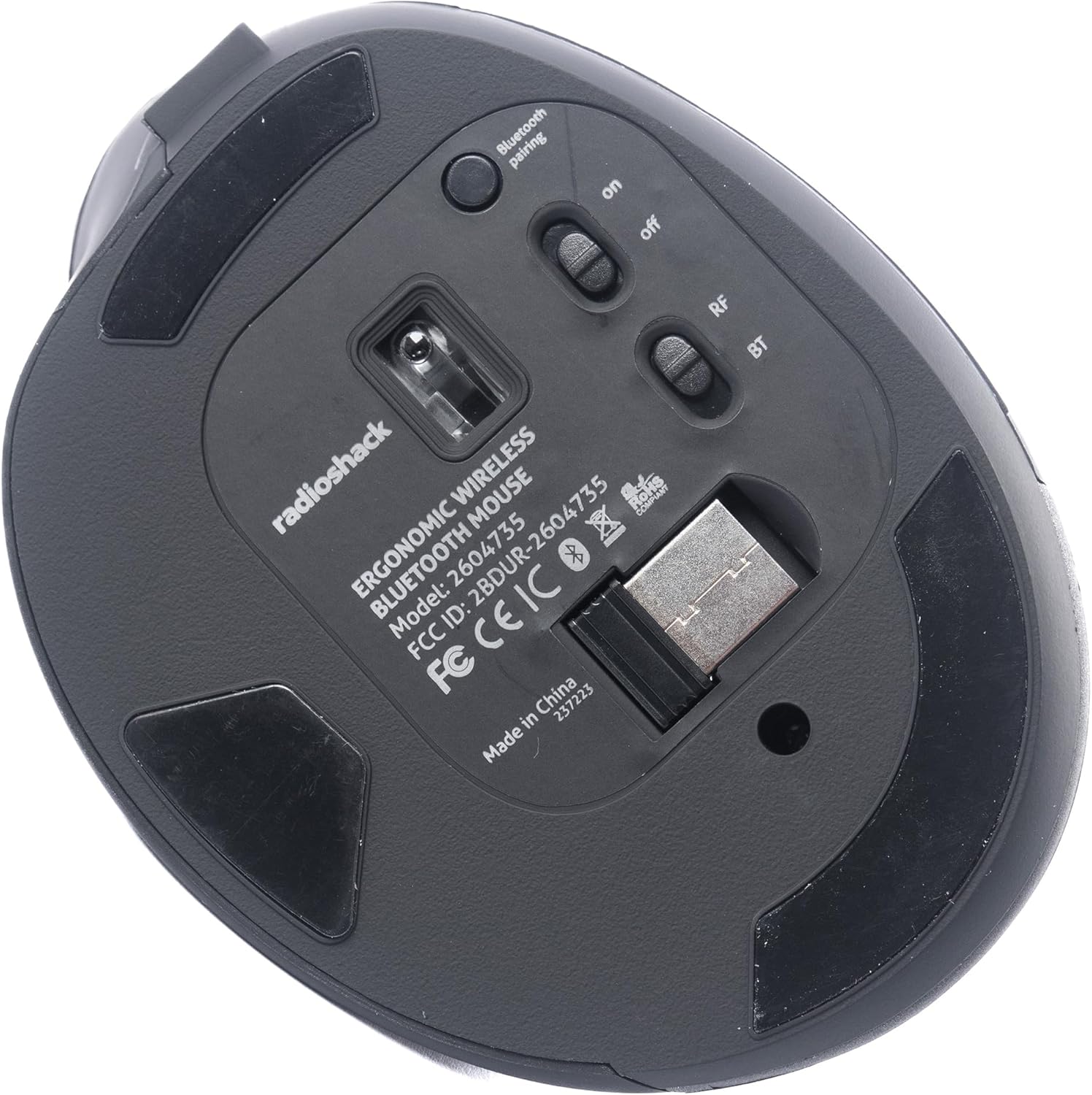 Bottom view of the RadioShack mouse showing the power switch, mode switch, and USB receiver storage