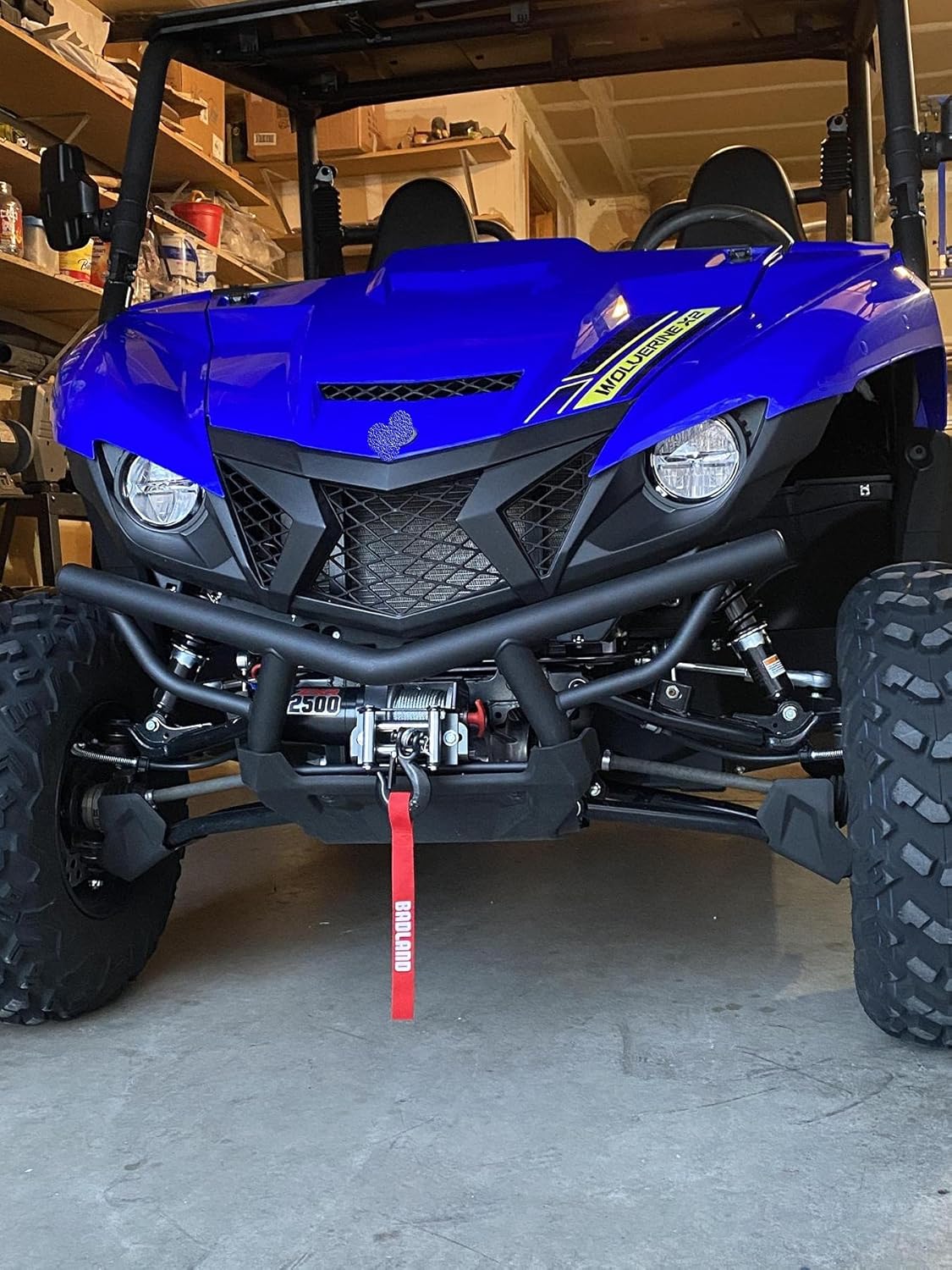 Front view of an ATV with the HFT Badland ZXR 2500 Lb. Utility Winch installed, showing the wire rope and roller fairlead.