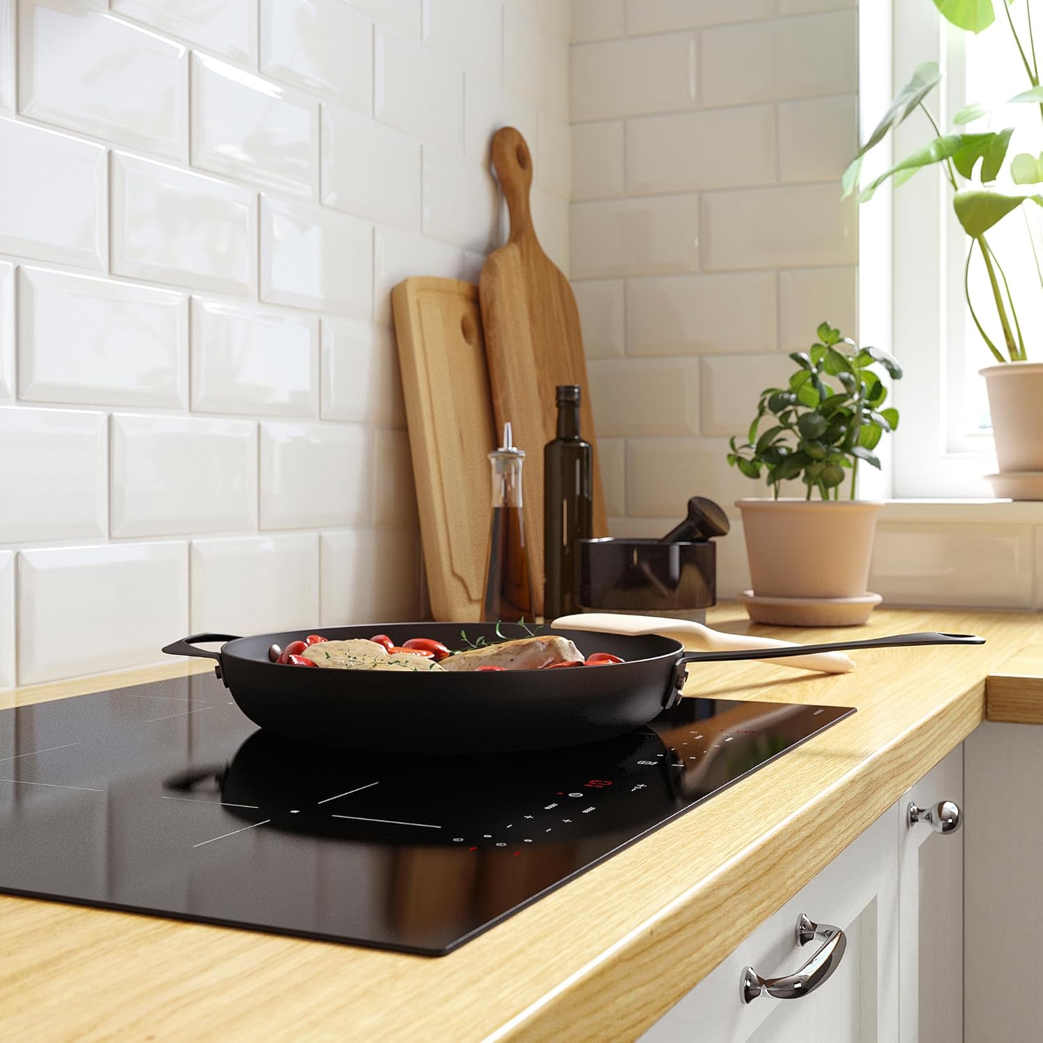 Induction hob with a frying pan cooking food, showing active cooking zone