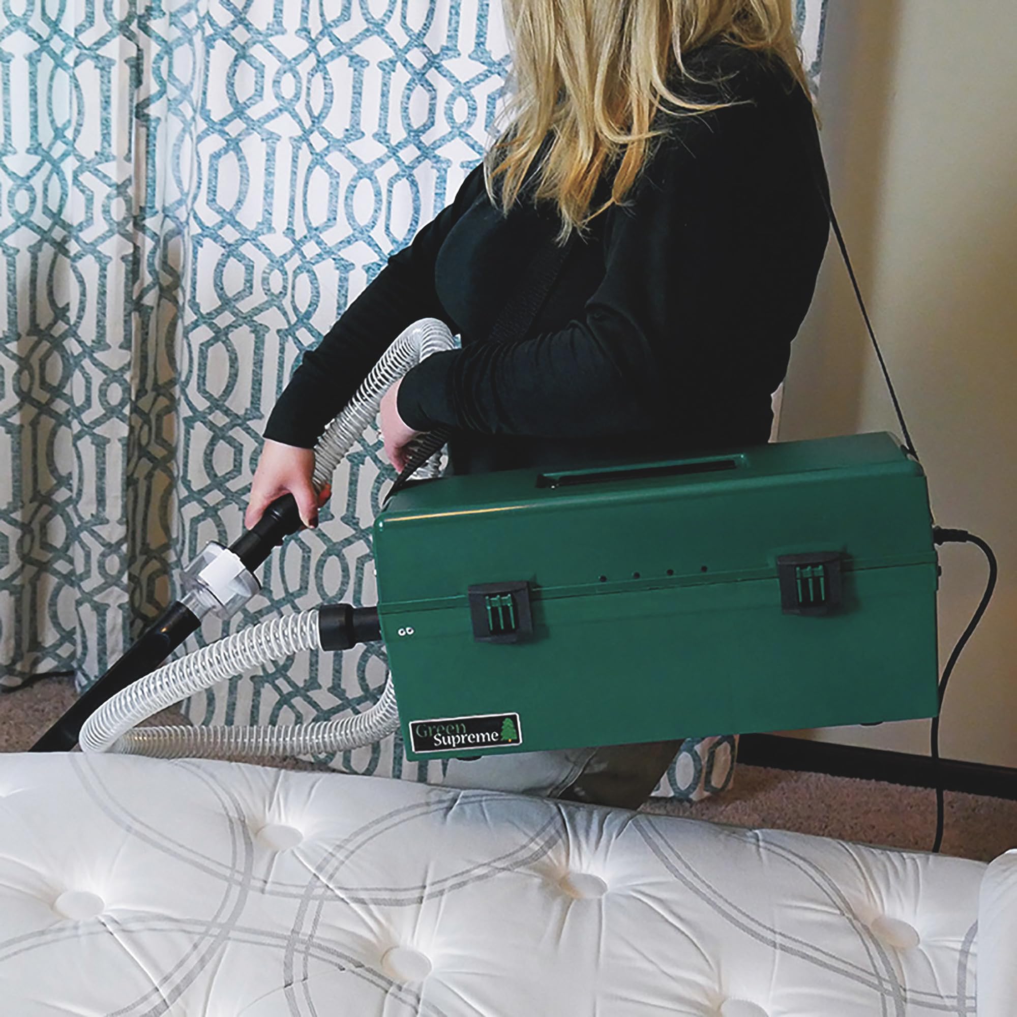 Person using Atrix Omega Green Supreme Vacuum with shoulder strap