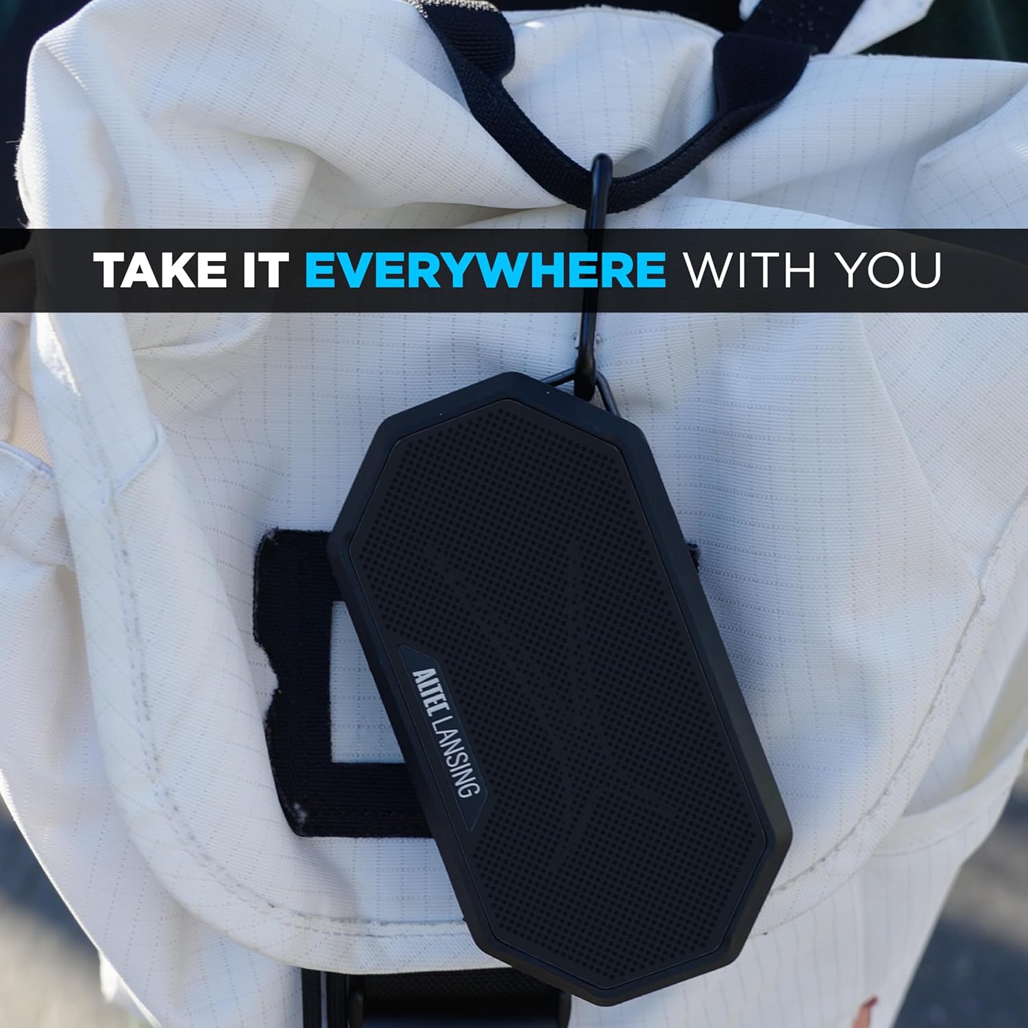 Altec Lansing HYDRAMINI 2.0 speaker with a carabiner clip attached to a backpack strap.