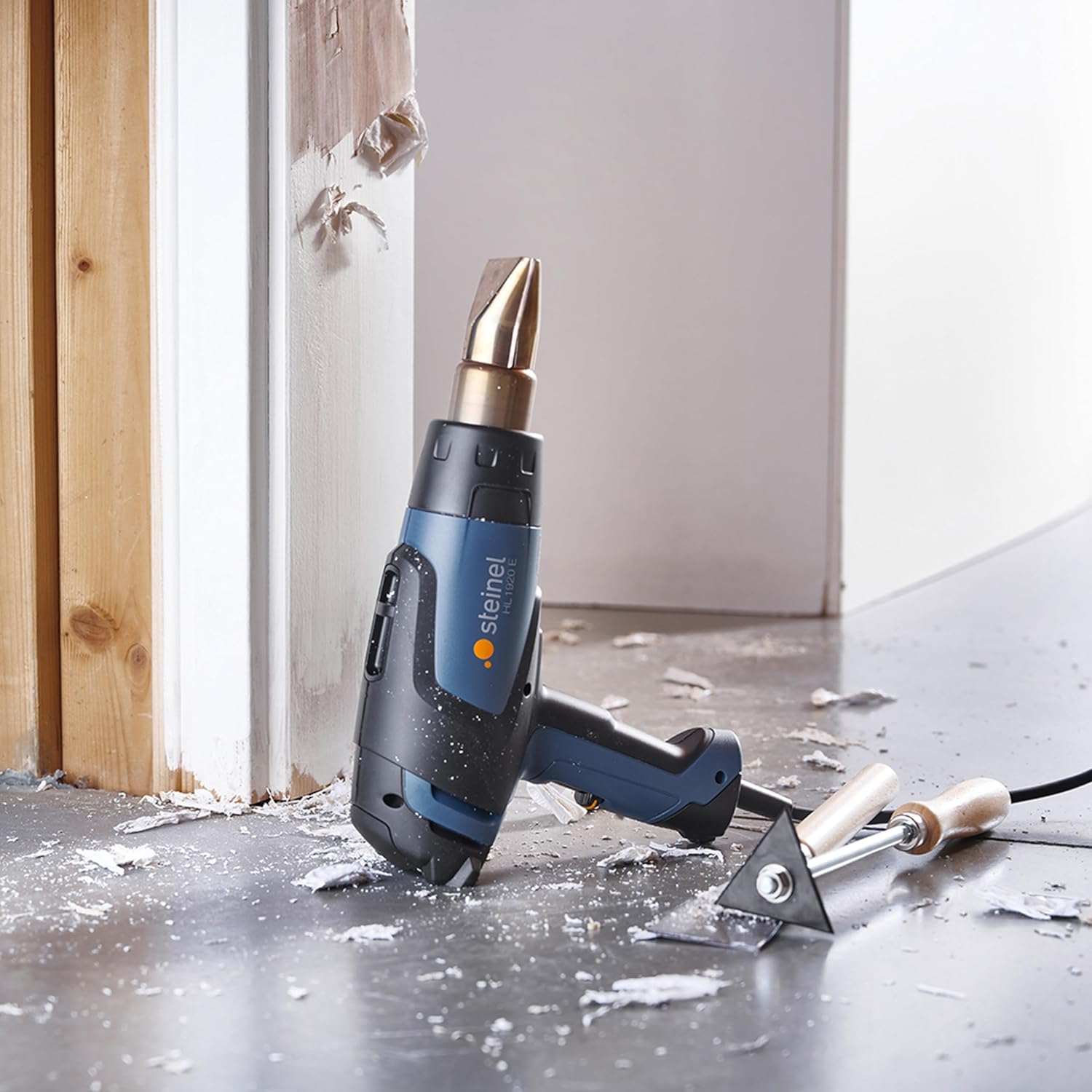 Steinel HL 1920 E Heat Gun being used to strip paint from a door frame