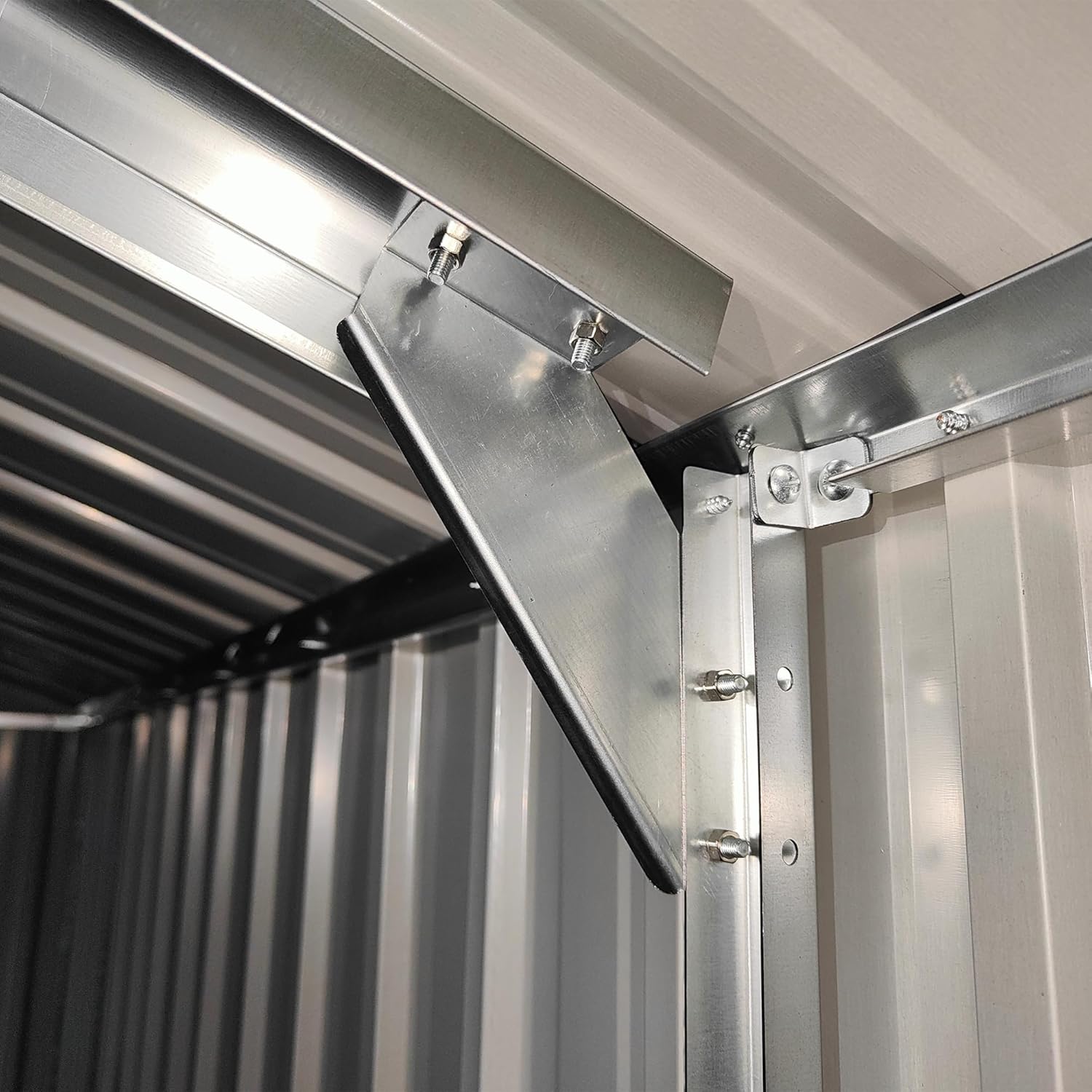 Close-up view of the interior roof structure and sturdy beams of the storage shed.
