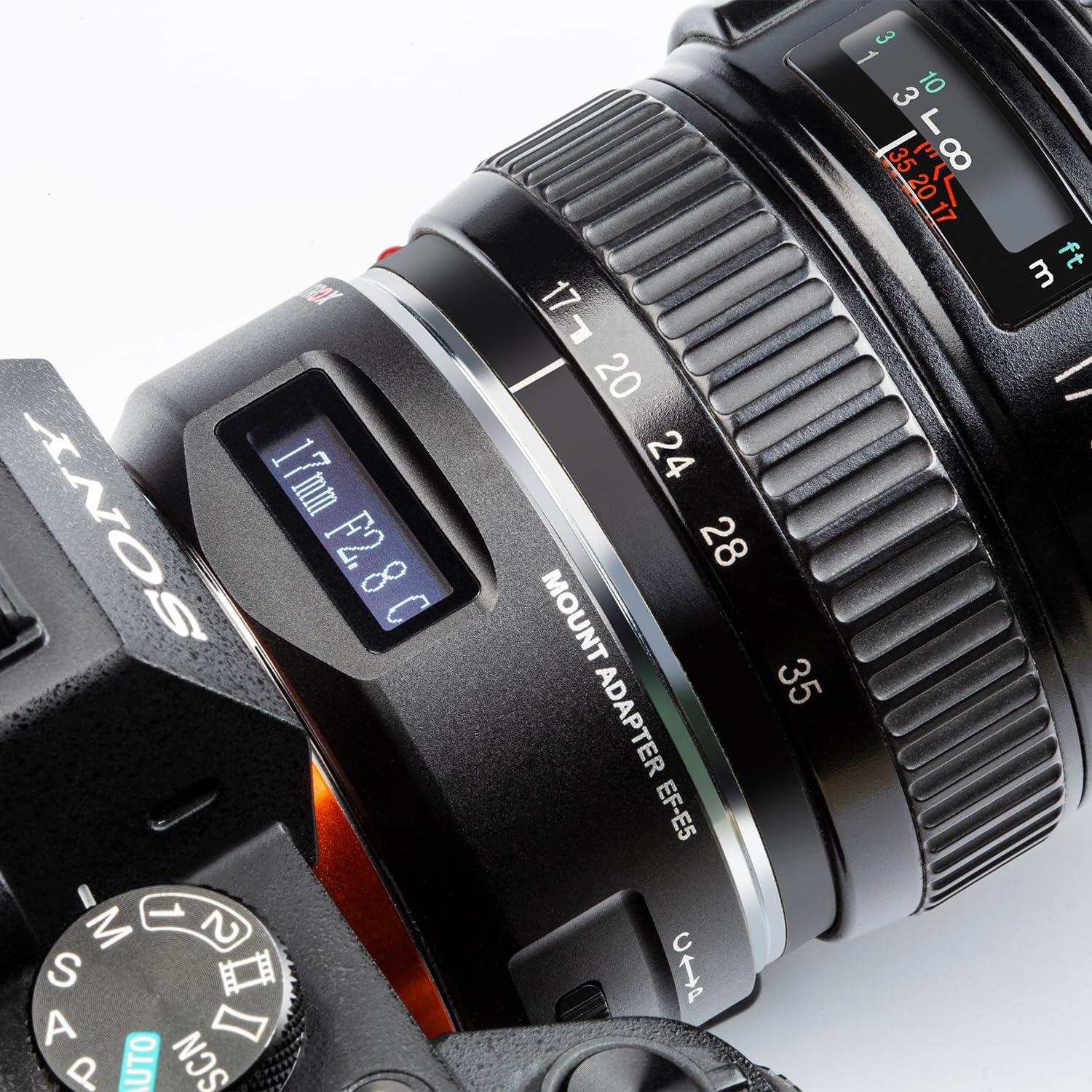 Close-up of the VILTROX EF-E5 adapter mounted on a Sony camera, with its OLED screen displaying '17mm F2.8 C', indicating focal length, aperture, and a mode setting.