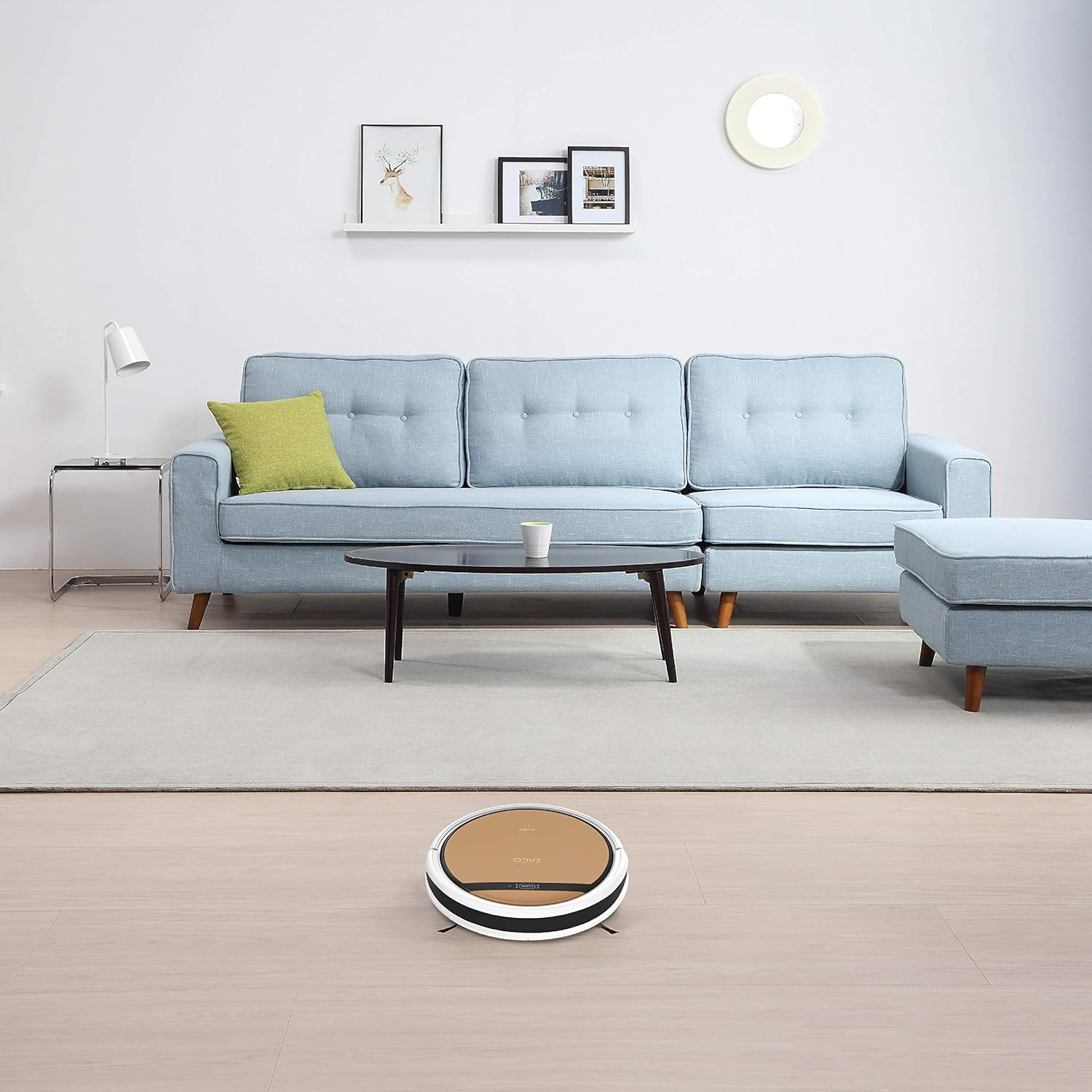 ZACO V5x robot vacuum cleaning a living room floor.