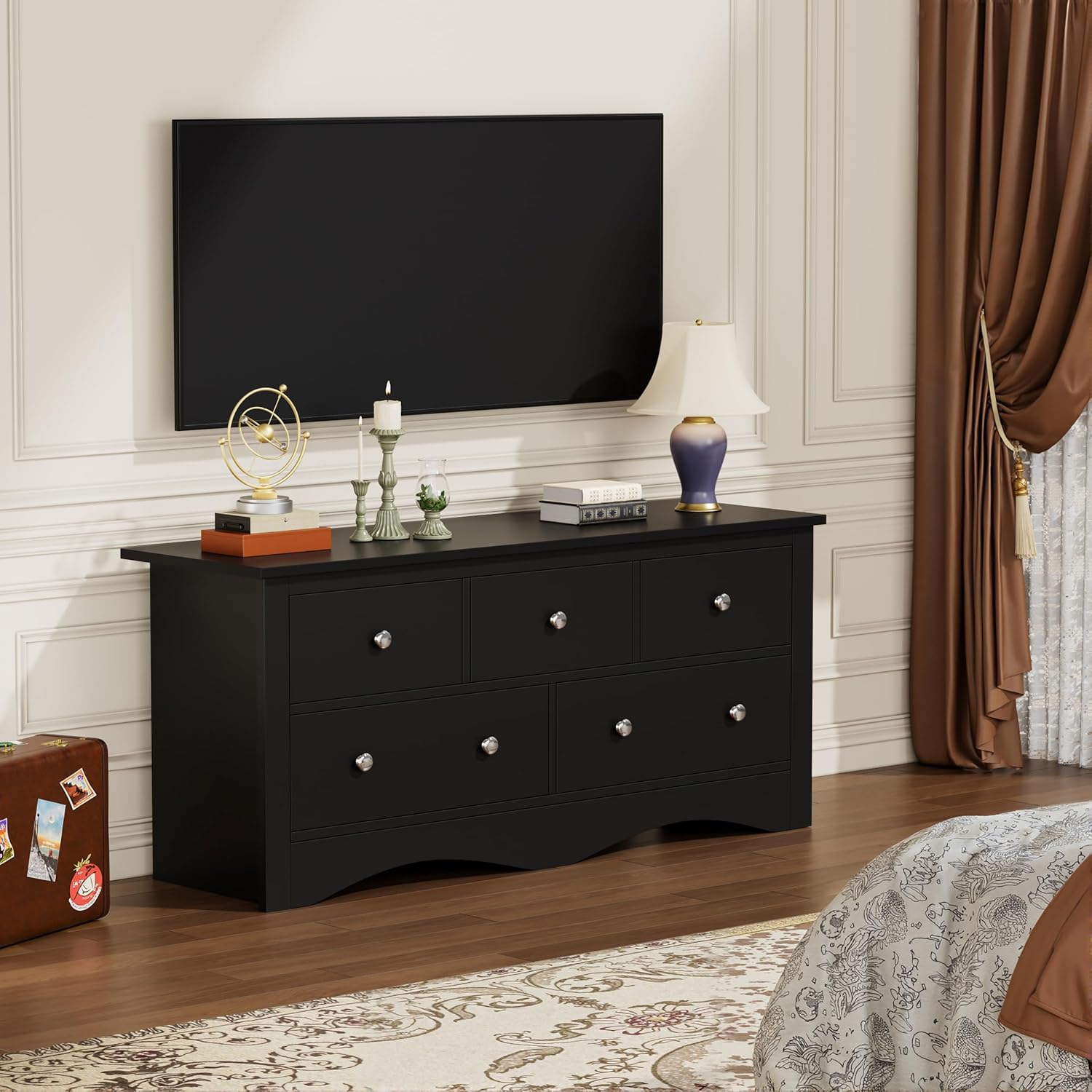 Dresser in a bedroom setting with a lamp and decorative items