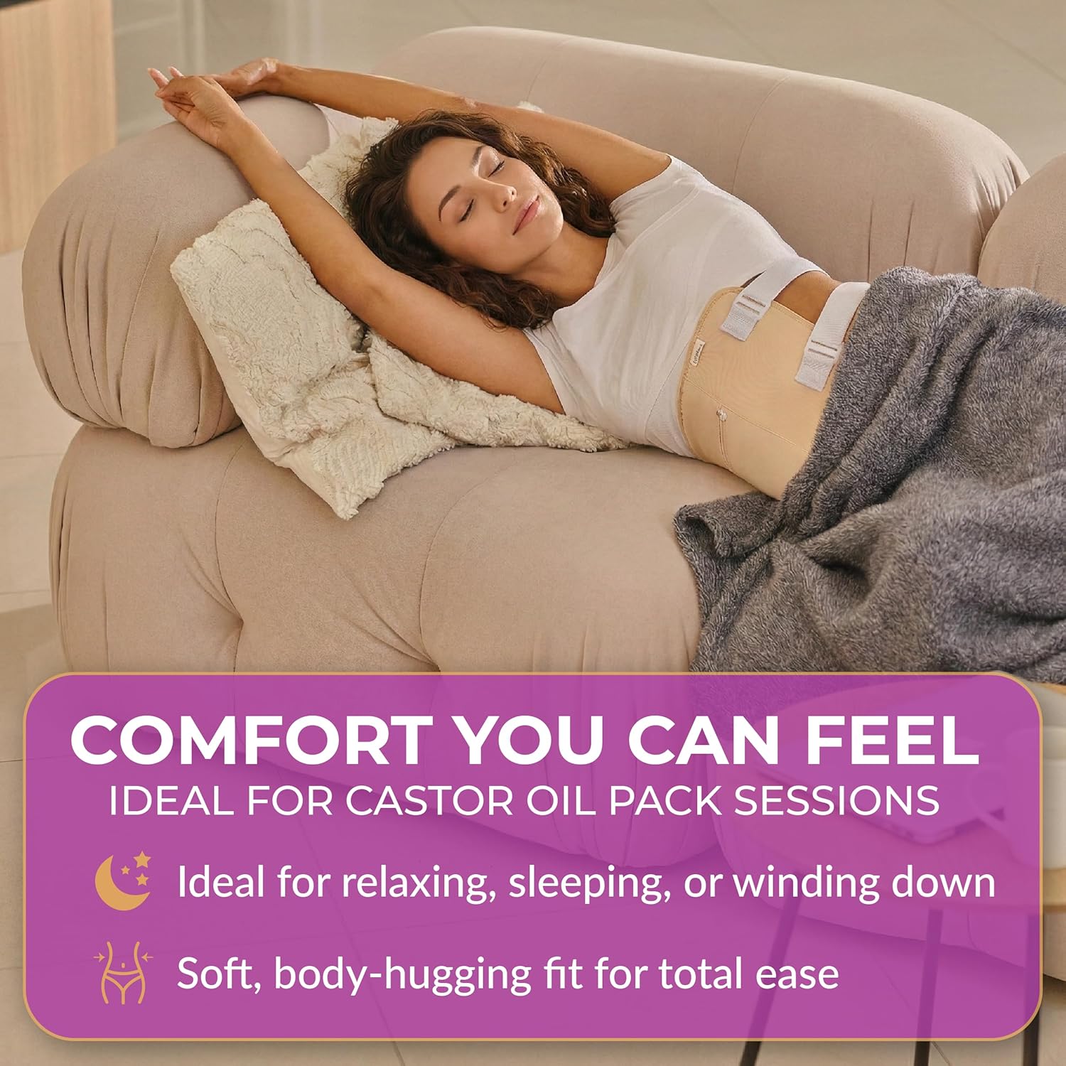 Woman relaxing on a couch while wearing the BELMAK Castor Oil Pack Wrap, illustrating comfort during use.
