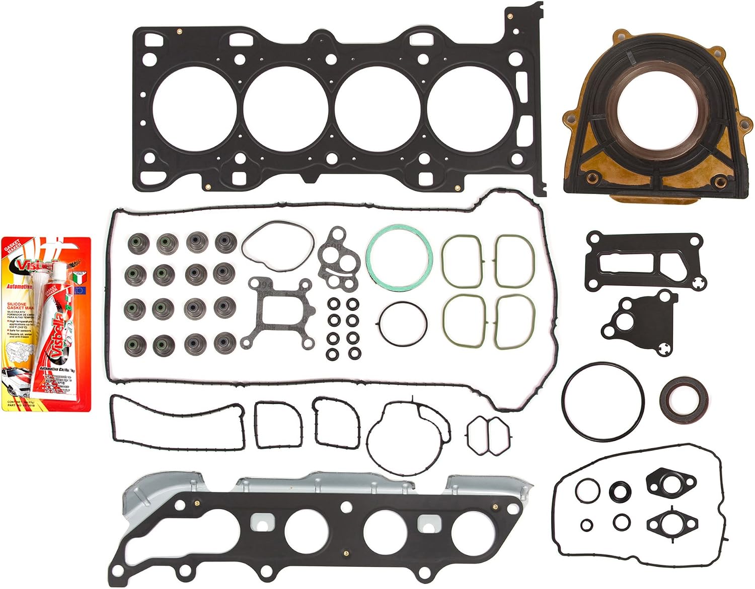 Complete gasket set laid out, including head gasket, manifold gaskets, seals, and silicone sealant.