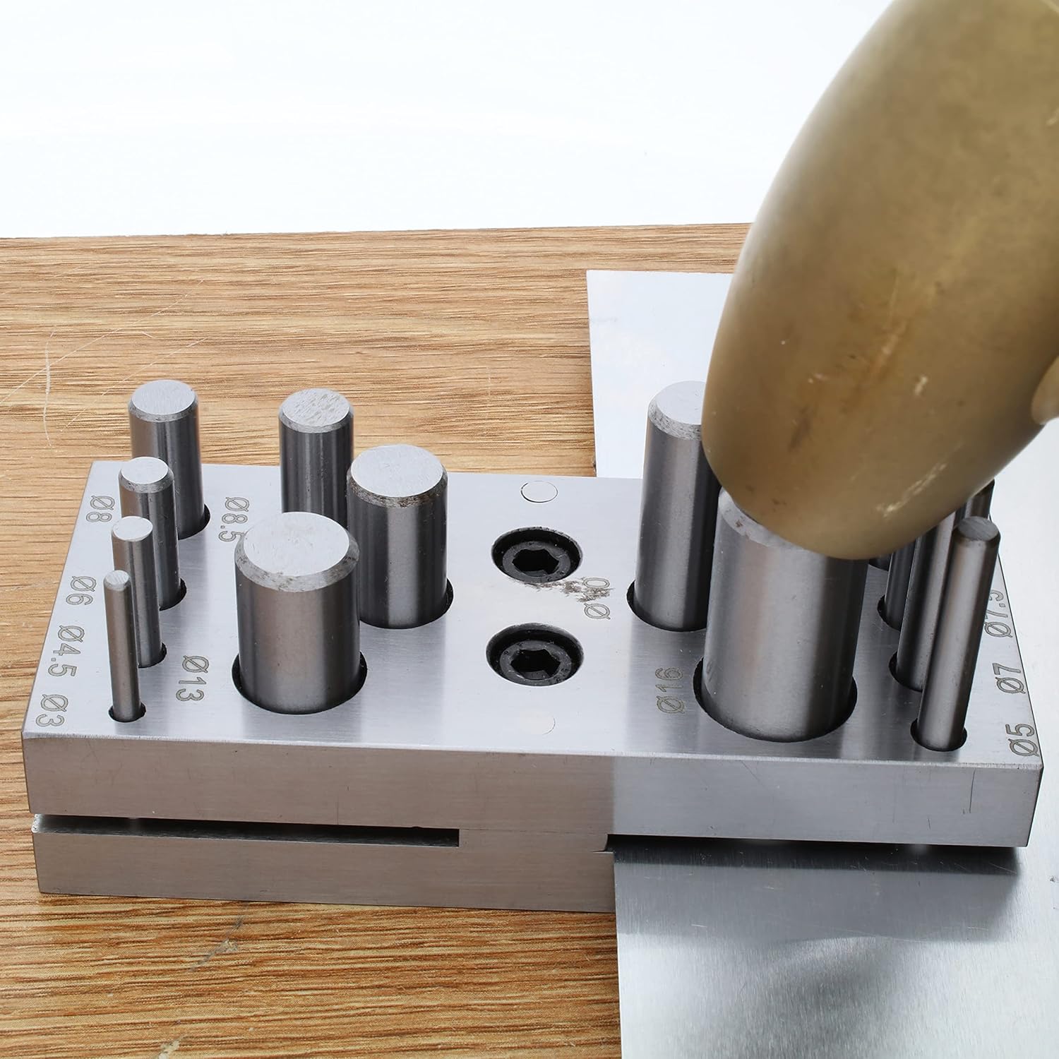 Hammer striking a punch in the disc cutter