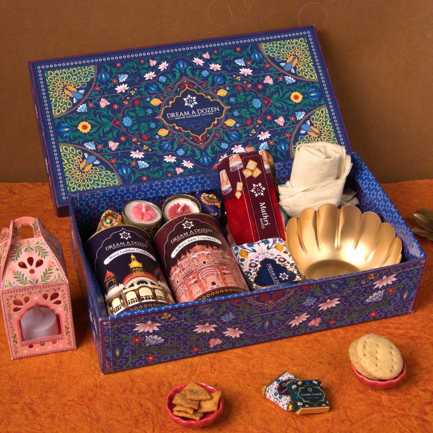 Dream a Dozen Azure Dream Gift Hamper | Premium Diwali Gift Box with Rava Laddoo Cookies, Achari Aam Crackers, Mathri Crackers, Indian Gourmet Chocolates, Functional Tote Bag, Auspicious Lotus Bowl, Elephant Tealight Holders, Festive Candles & Greeting Card | Luxury Festive Gift Hamper for Family, Friends, Clients & Employees | Corporate Diwali Gifts-image-48