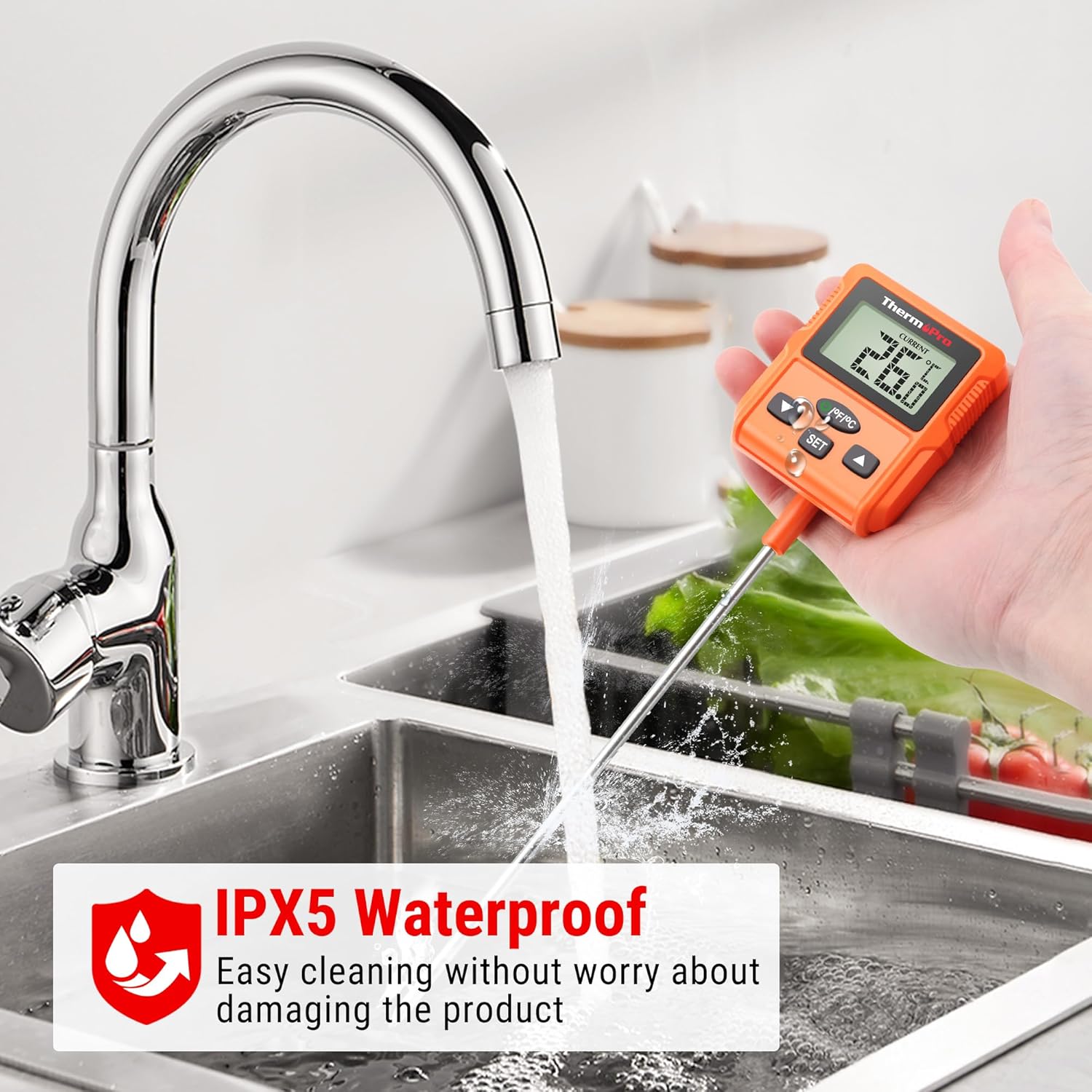 ThermoPro TP511 being cleaned under running water, demonstrating IPX5 waterproof rating