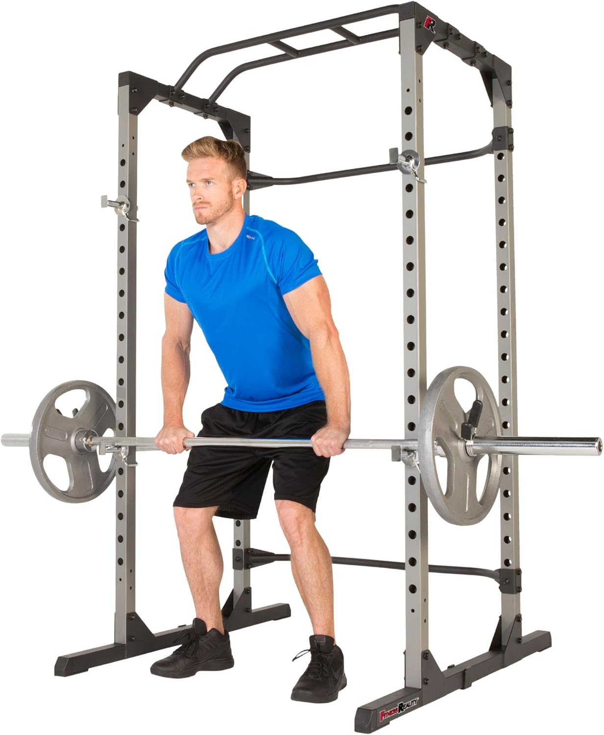 Man performing pull-ups on power cage