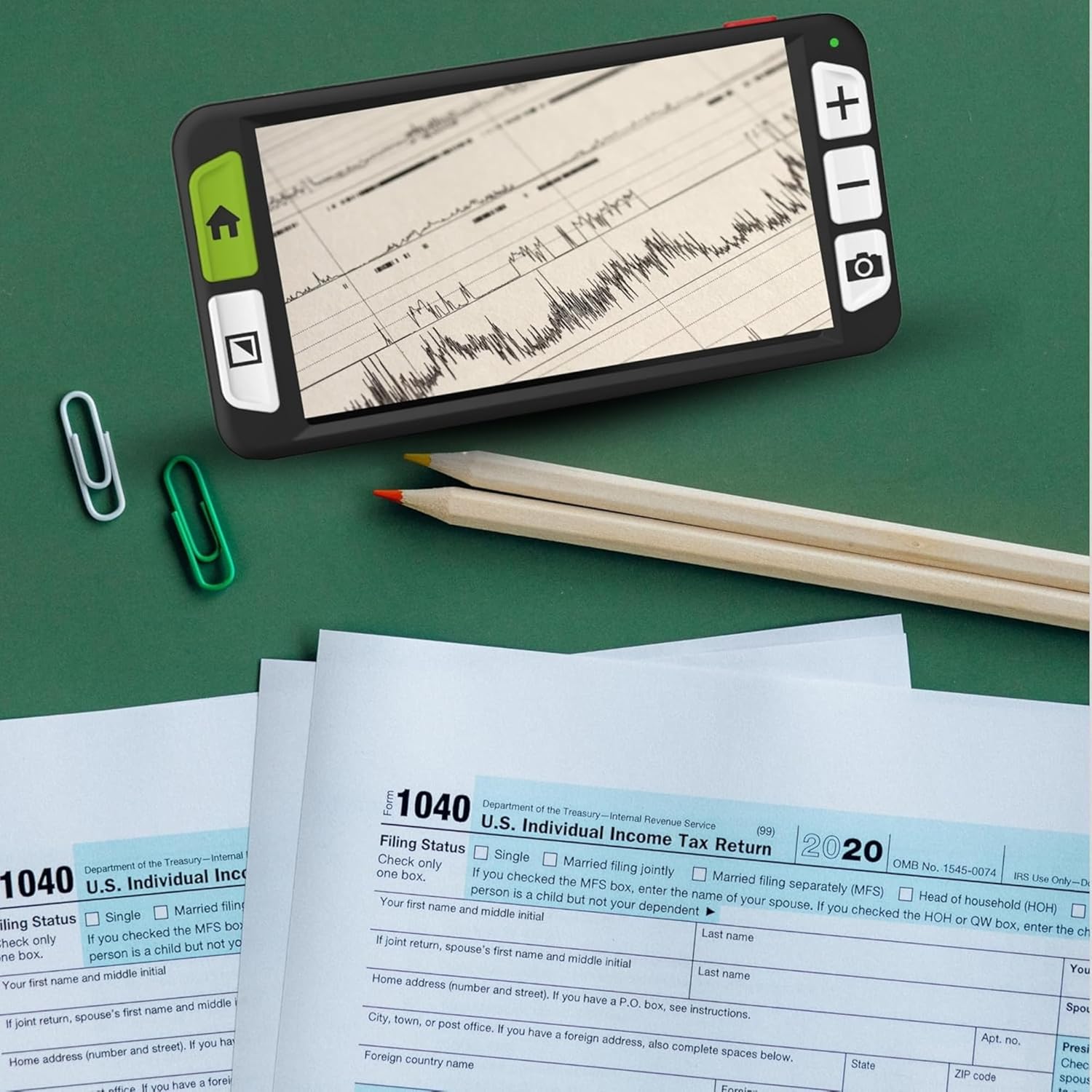 Zoomax Luna 6 magnifying a tax form on a desk with pencils and paperclips