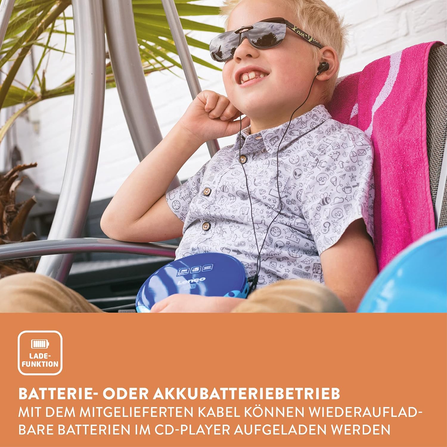 A child wearing headphones and holding the Lenco CD-011, illustrating battery operation and portability.