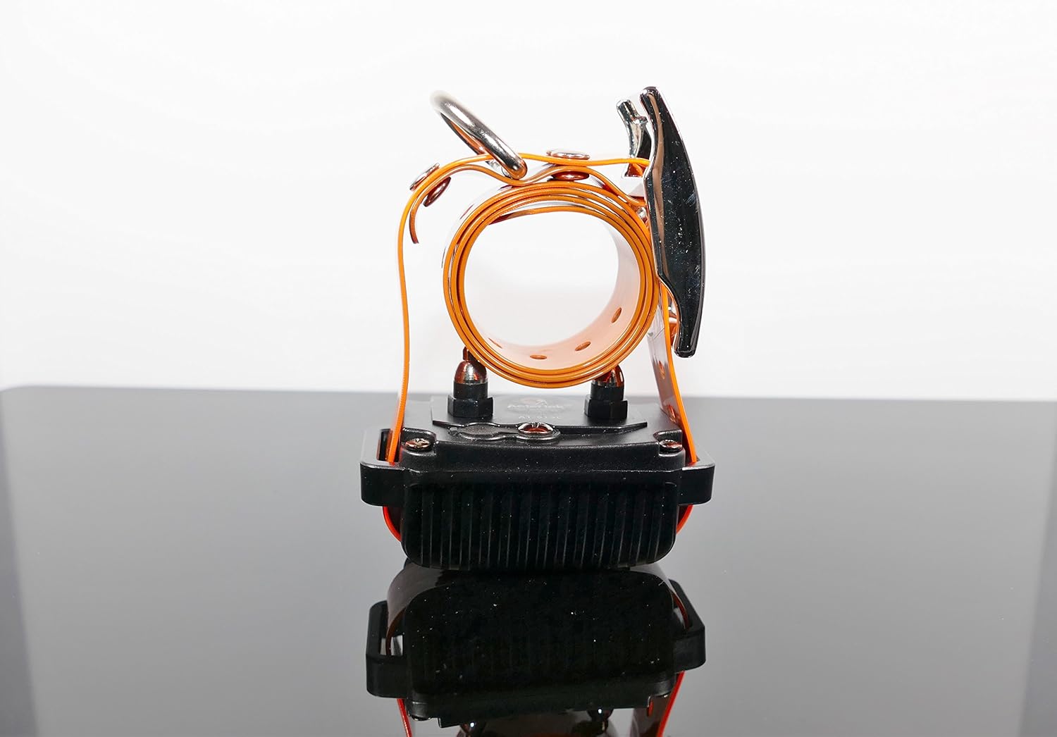 Aetertek AT-918C receiver collar rolled up, demonstrating its compact size and the orange strap.