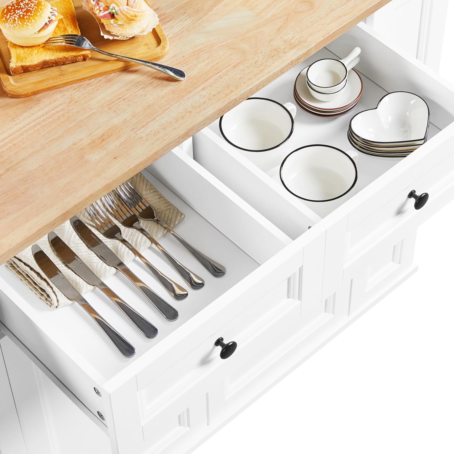 Top-down view of an open drawer in the Yaheetech kitchen cart, showing organized cutlery