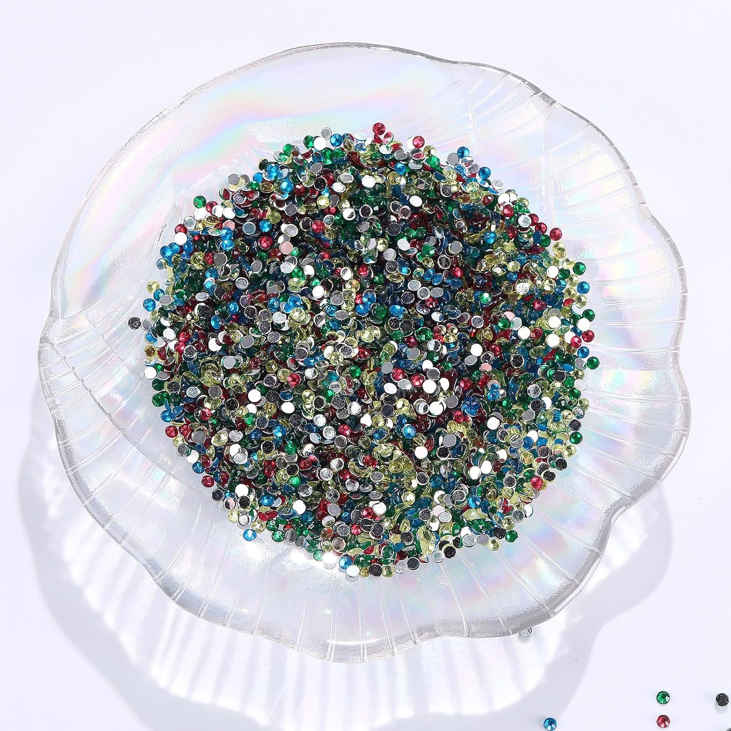 A clear, shell-shaped bowl filled with a colorful mix of diamond painting beads, showcasing their vibrant appearance when combined.