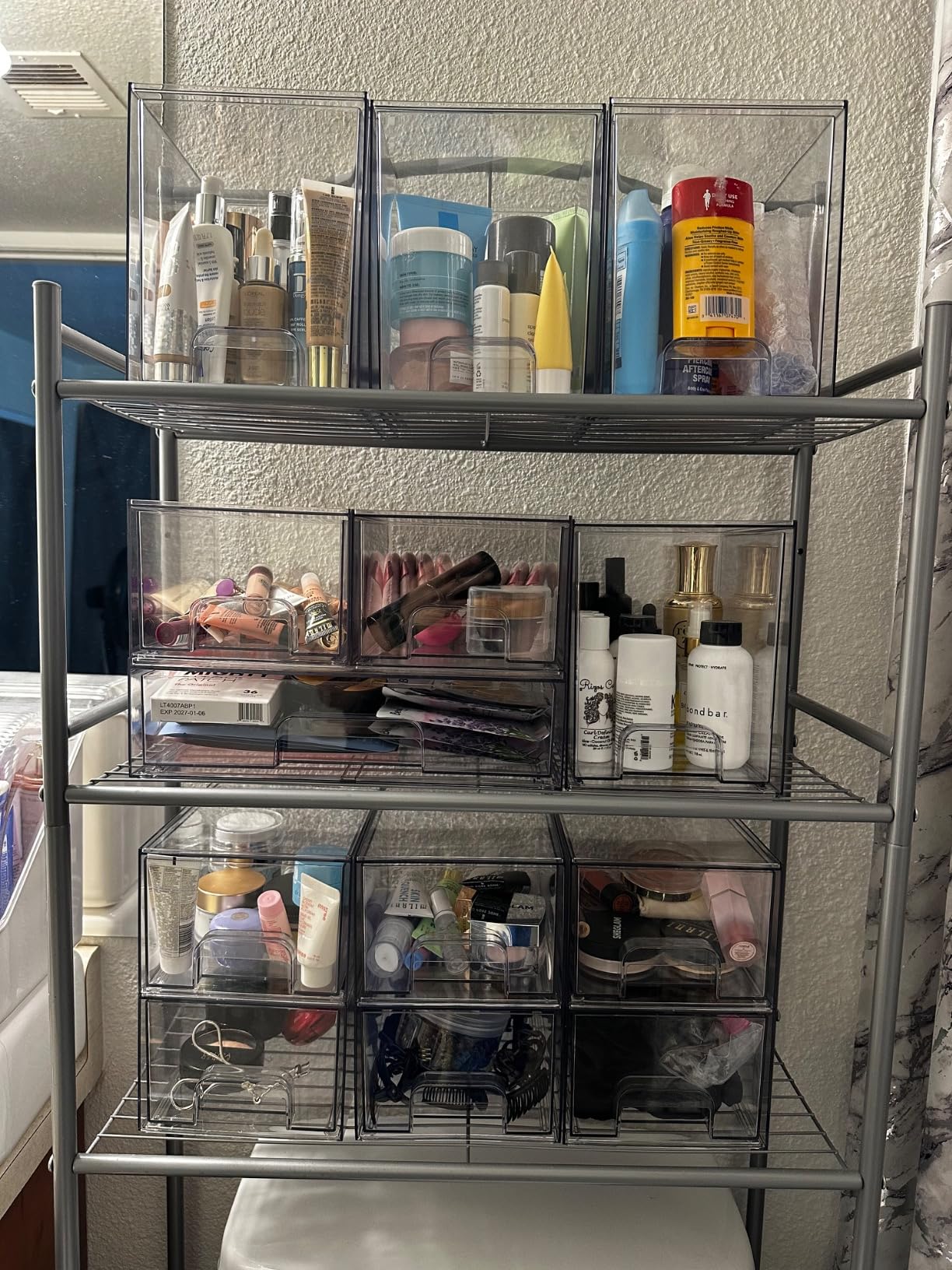 Tiered clear stackable storage drawers maximizing vertical vanity space