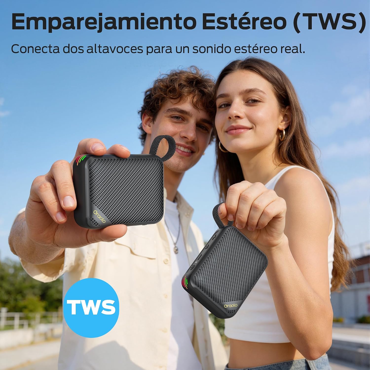 Two oraolo BS17 speakers being held by two people, illustrating the True Wireless Stereo (TWS) pairing feature.
