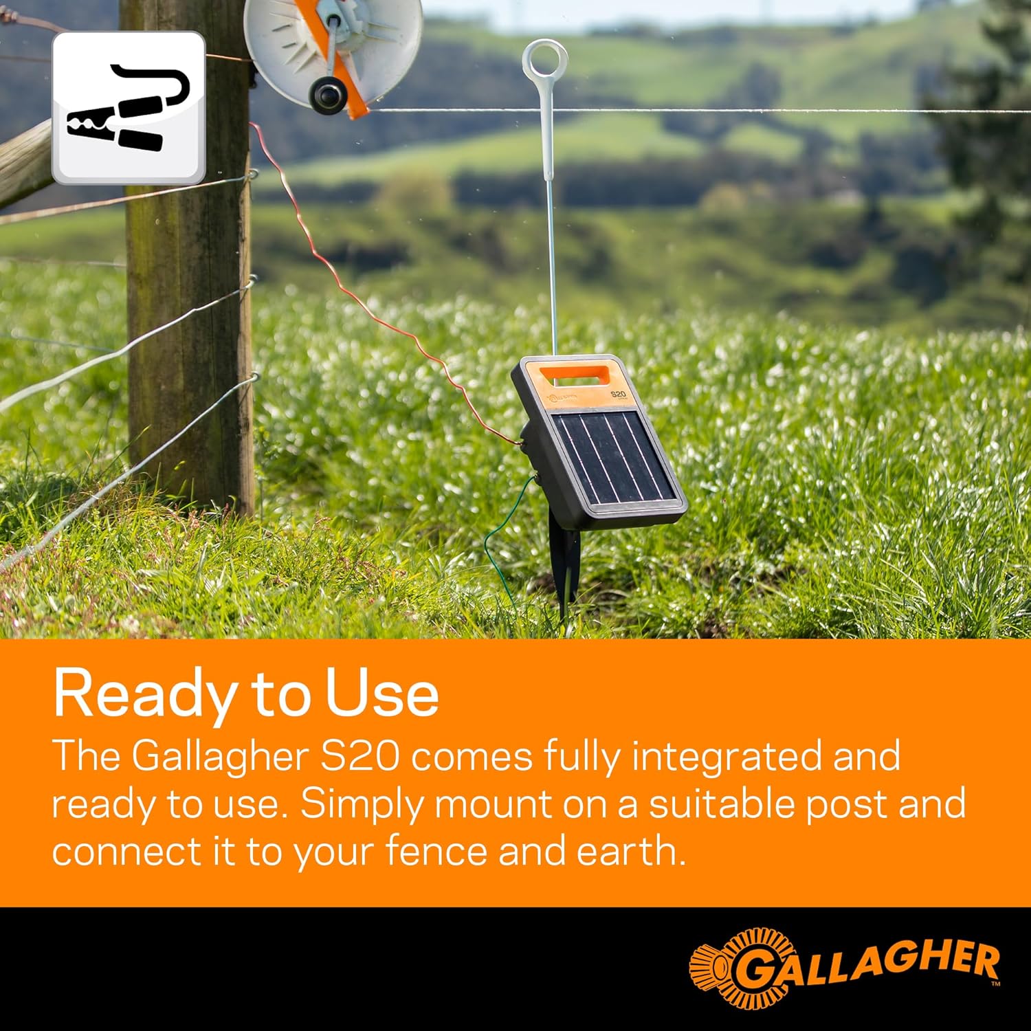 Gallagher S20 Solar Electric Fence Charger installed on a post in a grassy field, with fence and earth leads connected.