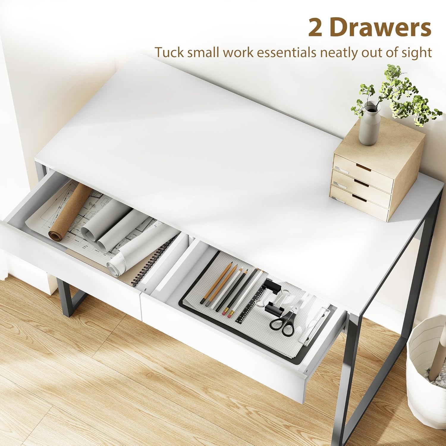 Per sobre view of the desk with two drawers pulled out, revealing office essentials like paper rolls, pencils, and scissors