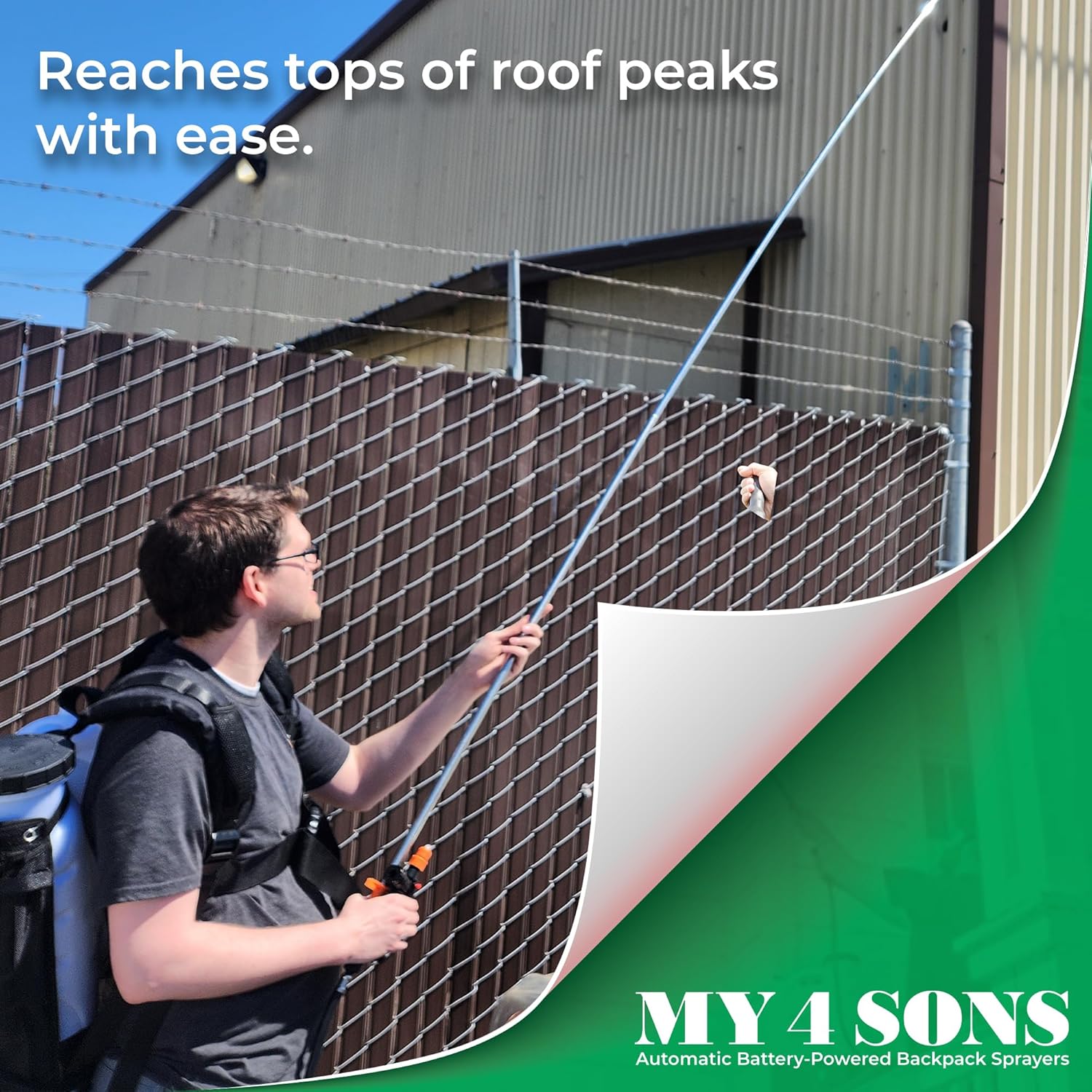 Person using the telescoping wand to spray a high roof peak
