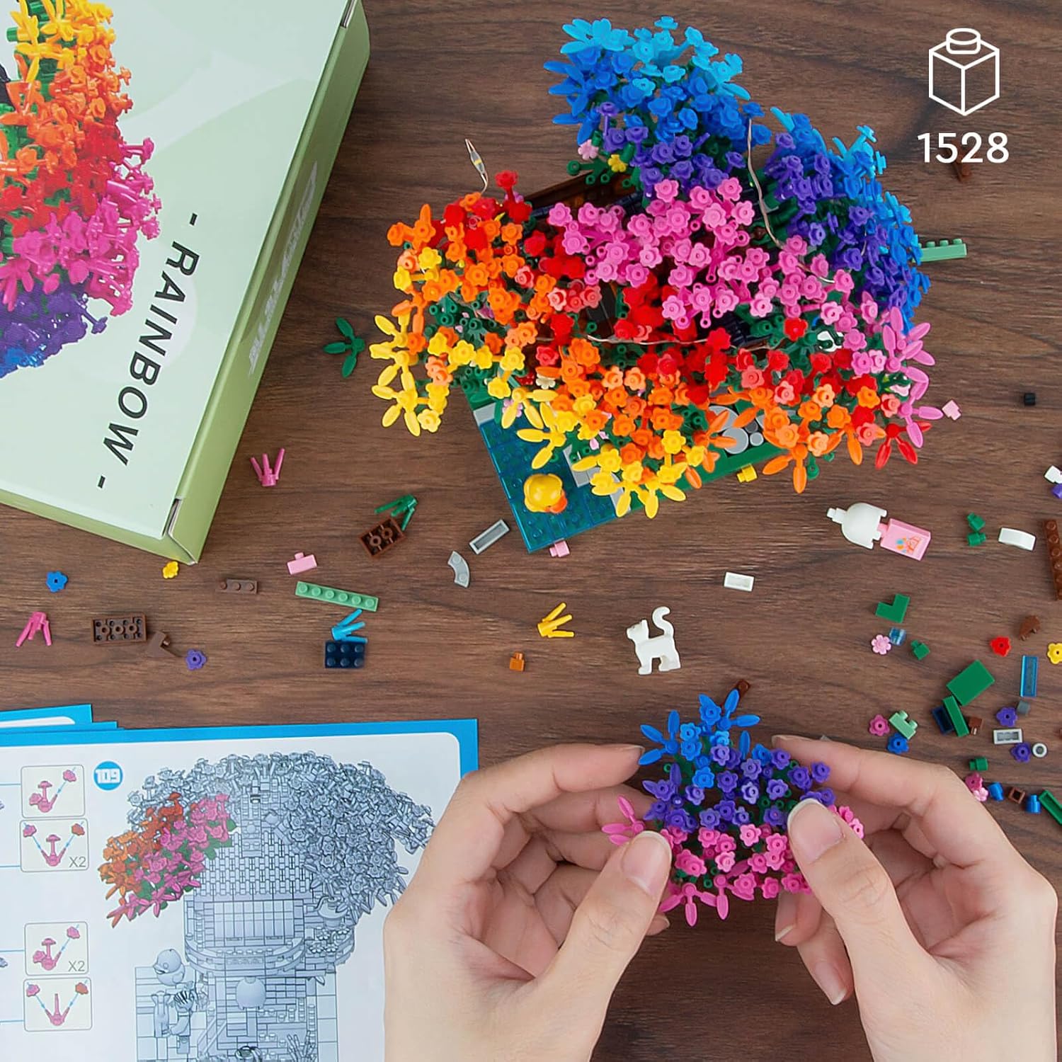 A person assembling the Vziimo Rainbow Treehouse Set, showing the scale of the micro blocks.