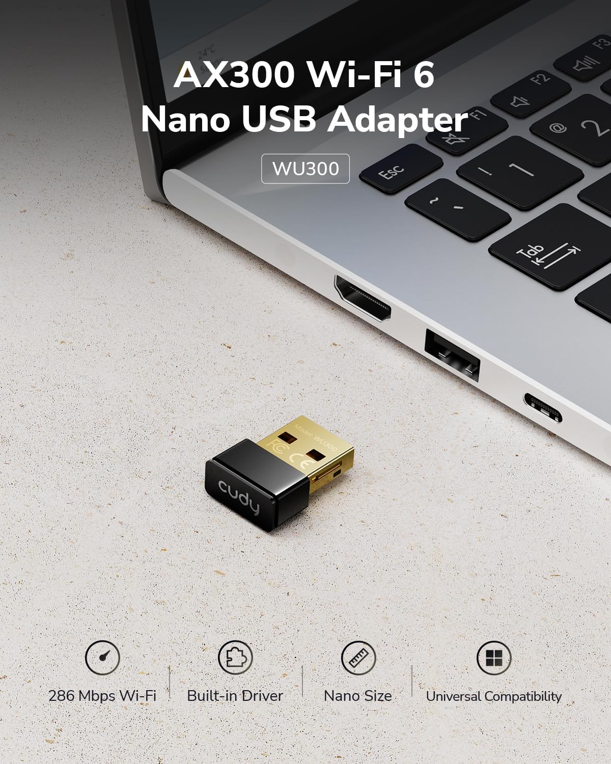 Cudy AX300 WU300 Nano USB Adapter plugged into a laptop, showing its compact size.