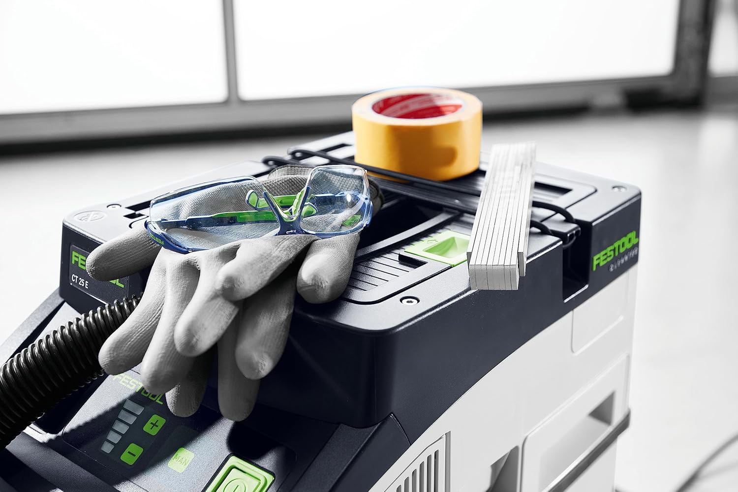 Person pulling Festool CT 25 with telescopic handle