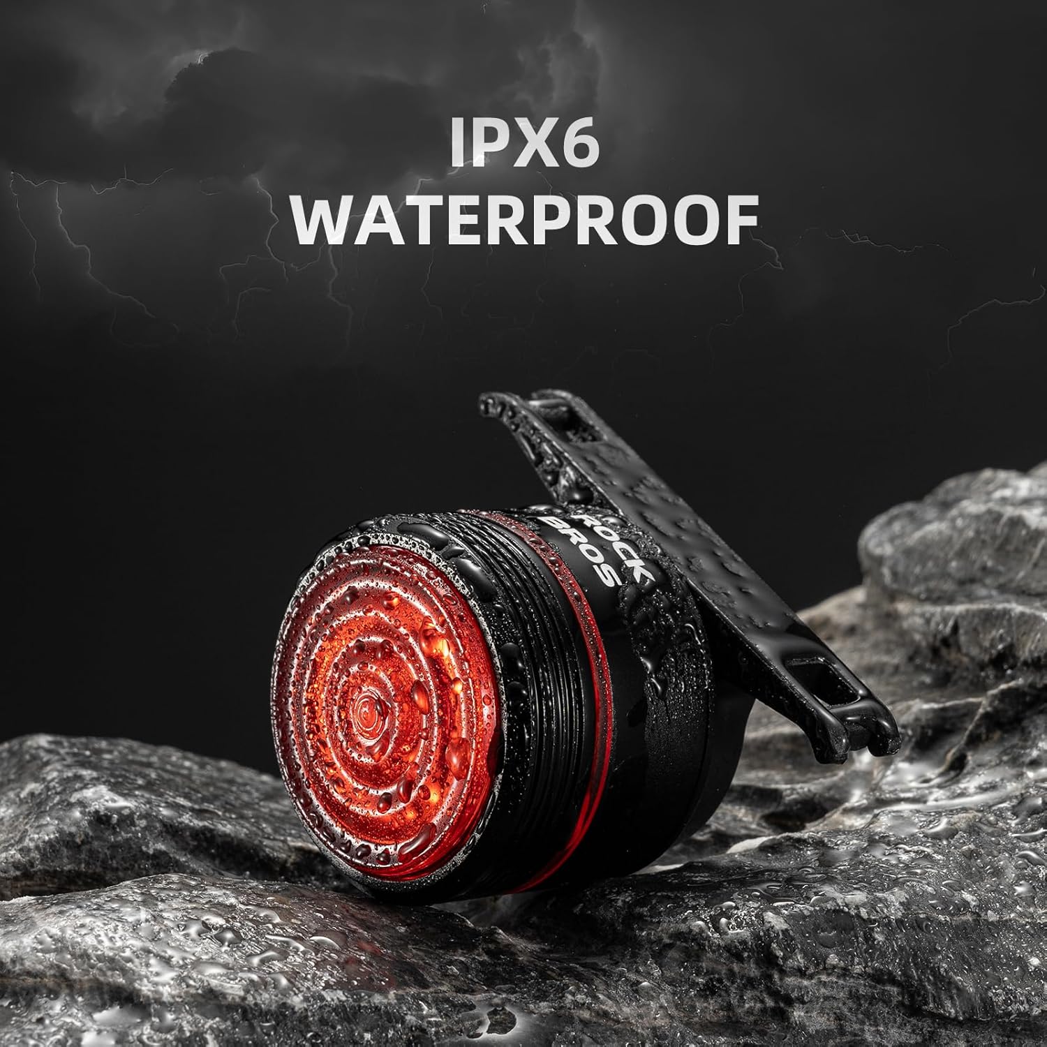 ROCKBROS Bike Tail Light on a wet, rocky surface, demonstrating IPX6 waterproof rating