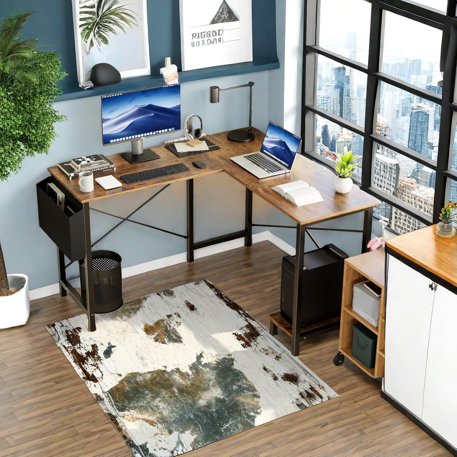 An L-shaped desk set up in a corner with two monitors, a laptop, and various office accessories, showcasing its spacious design.