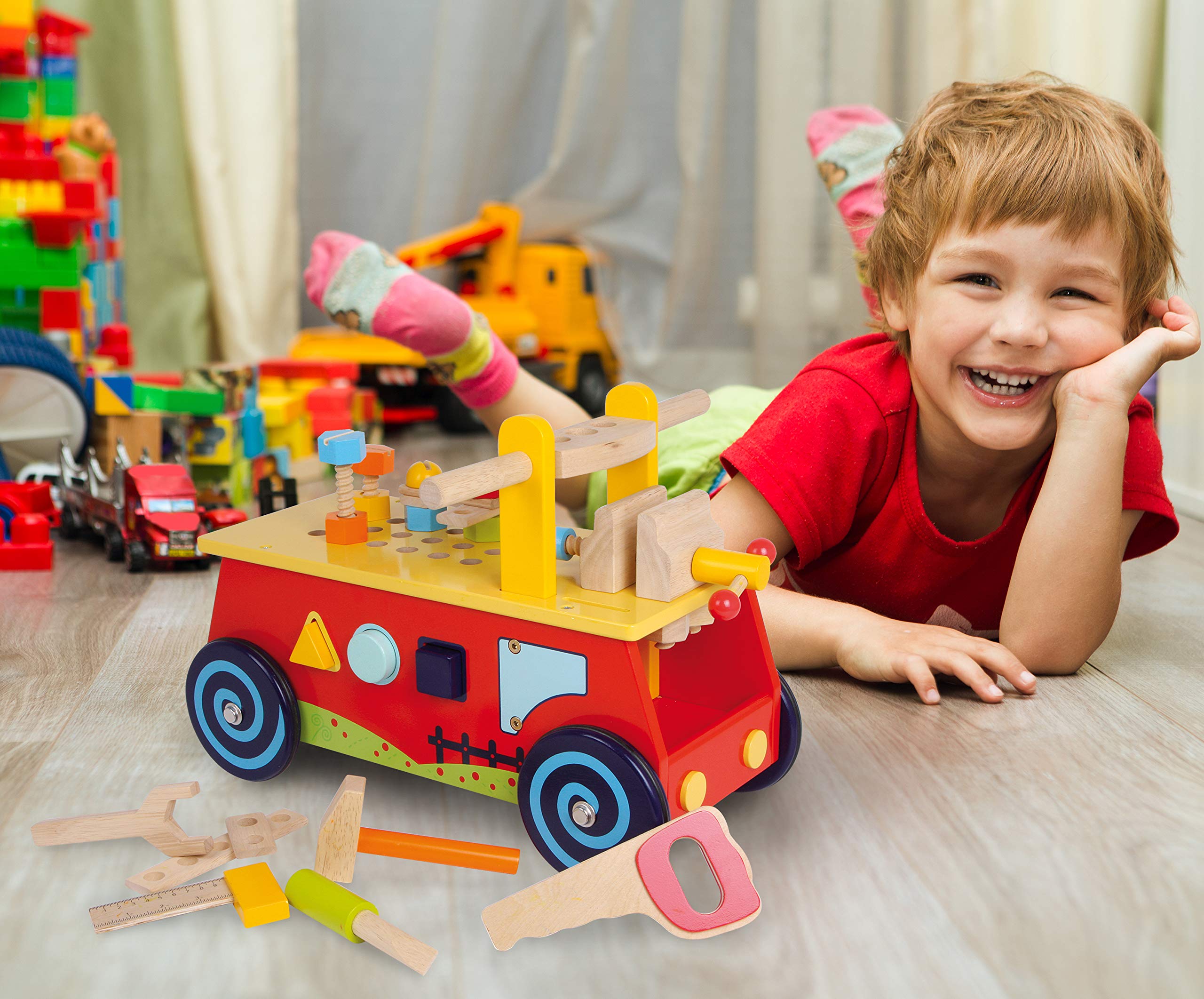 1595 Macchina primi passi «Banco da lavoro» small foot in legno, con tutti i tipi di accessori, divertimento ed apprendimento motorio, a partire da 2 anni.