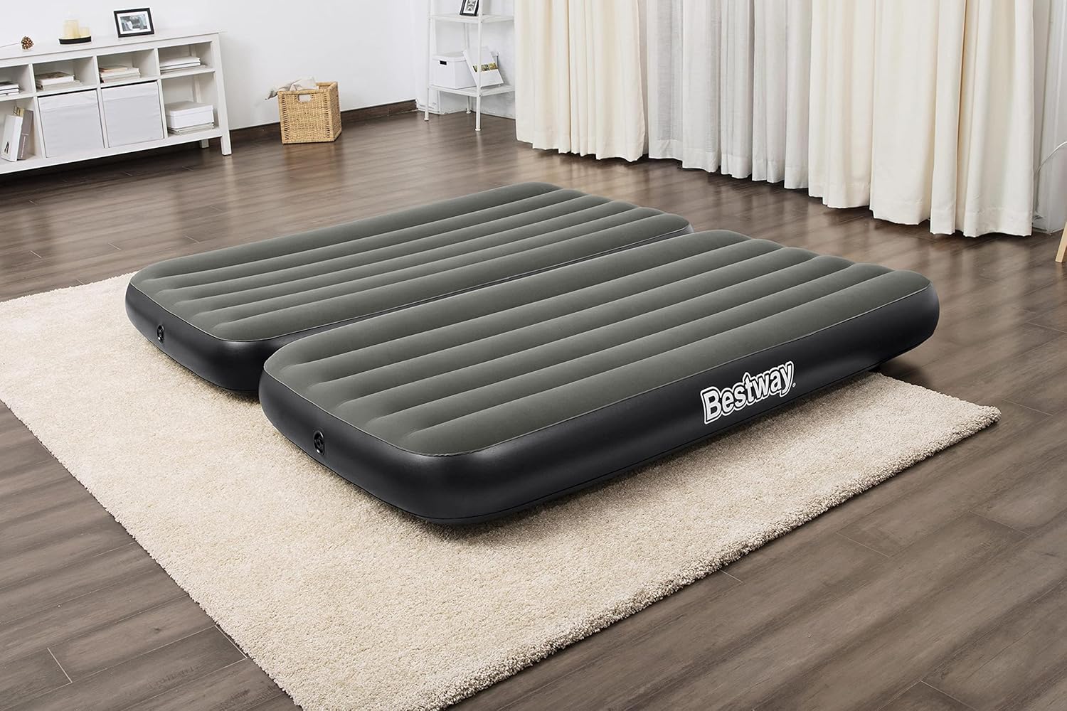 A woman relaxing on two stacked Bestway air mattresses, forming a double-layer twin bed