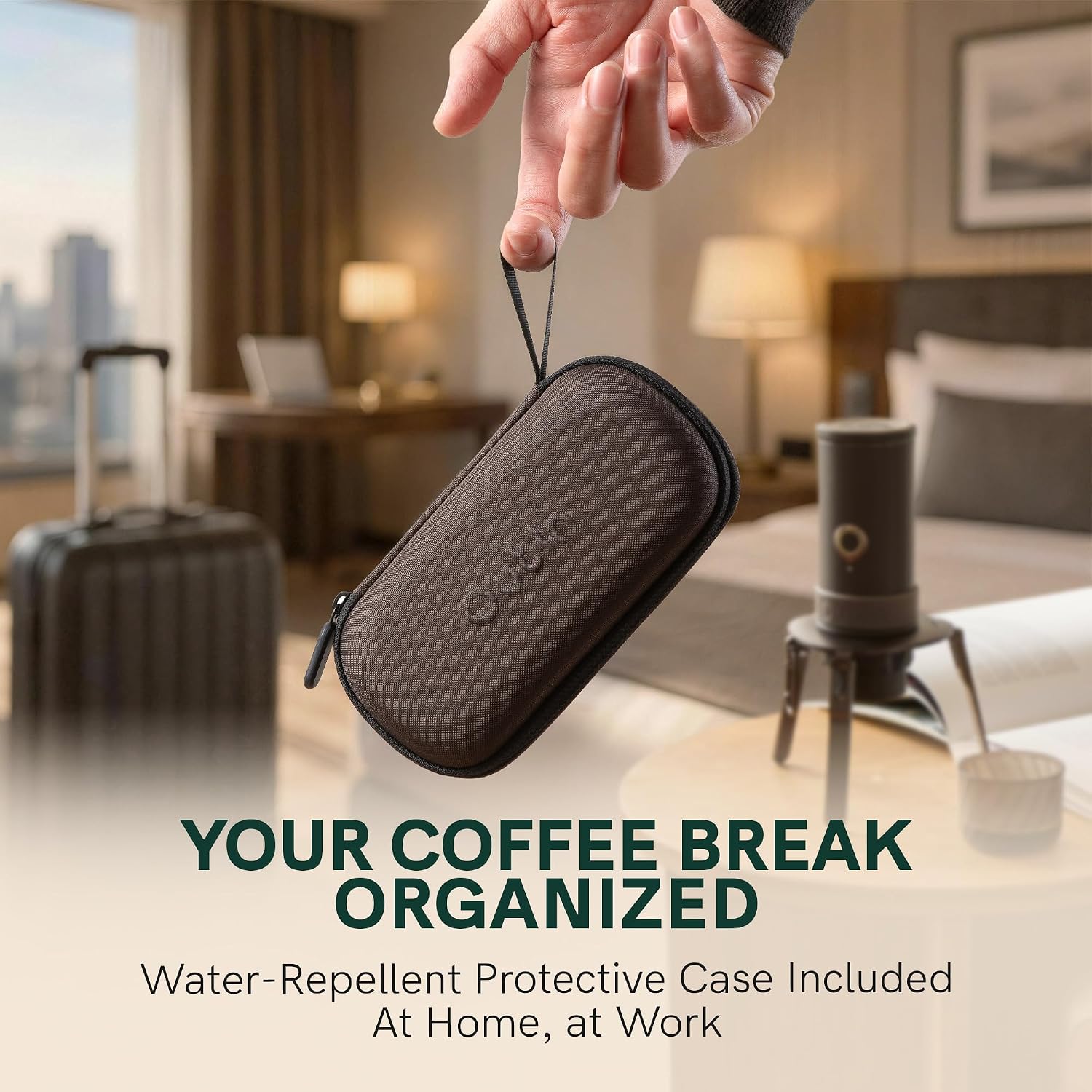 The OutIn LattoGo frother and its travel case on a table in a hotel room setting, emphasizing portability.