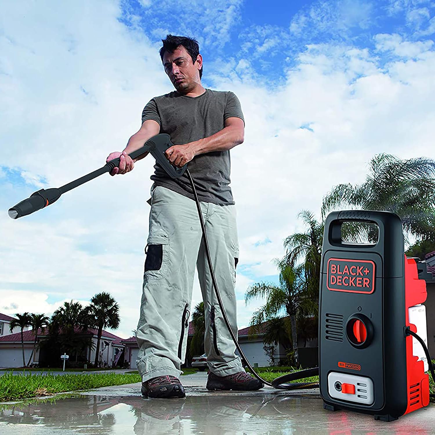 Person using pressure washer to clean a patio